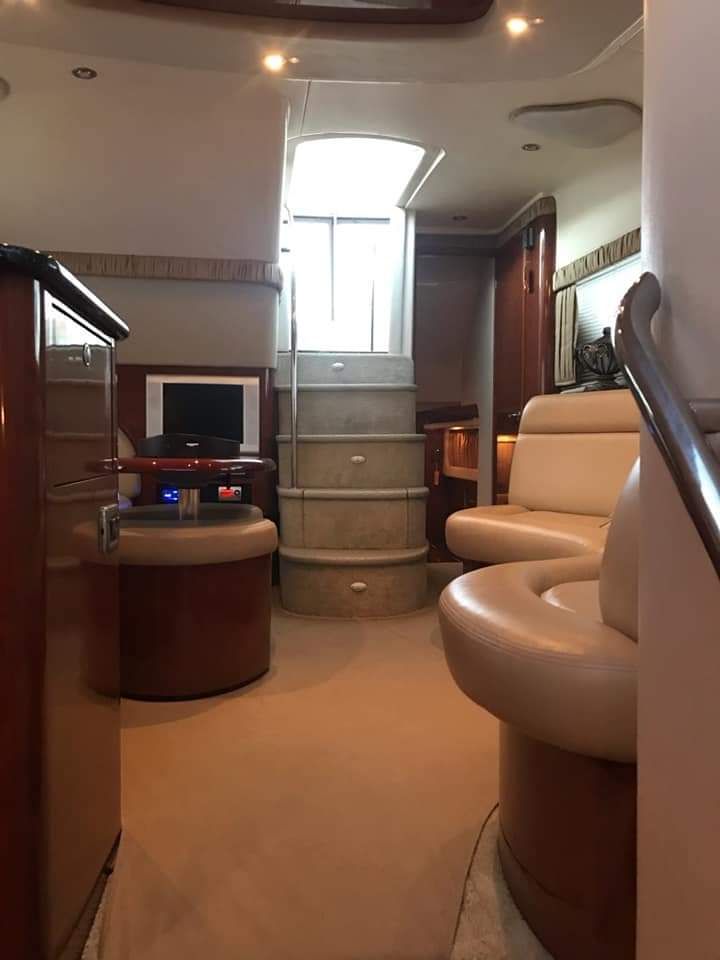 Interior of a 2004 Sea Ray Sedan Bridge with elegant furnishings and a staircase.
