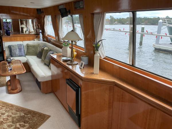 Luxurious interior of 2000 Novatec Islander 55 yacht with elegant wood finish and waterfront view.