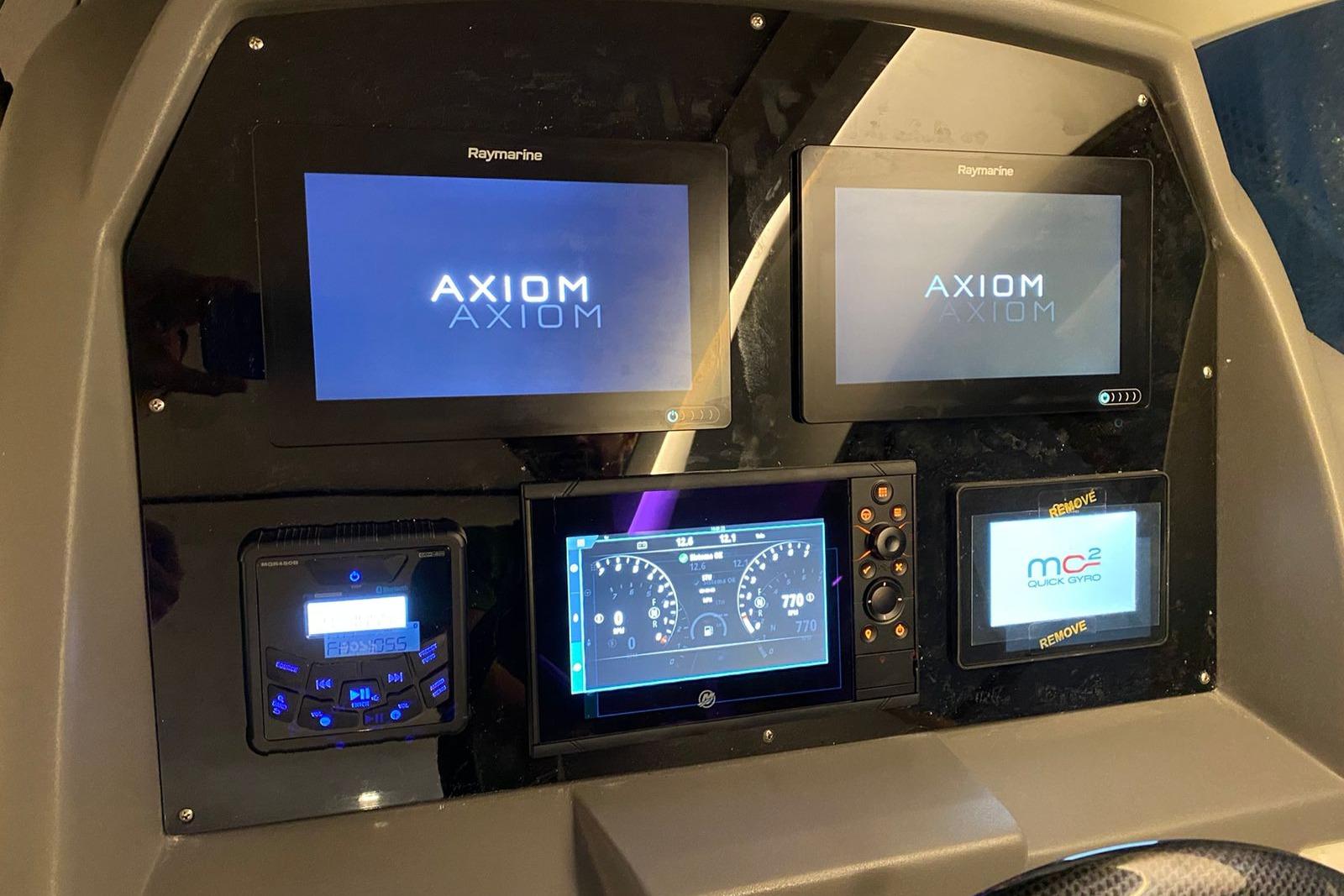 Control panel of a 2026 Hanover 375 with multiple digital displays and navigation systems.