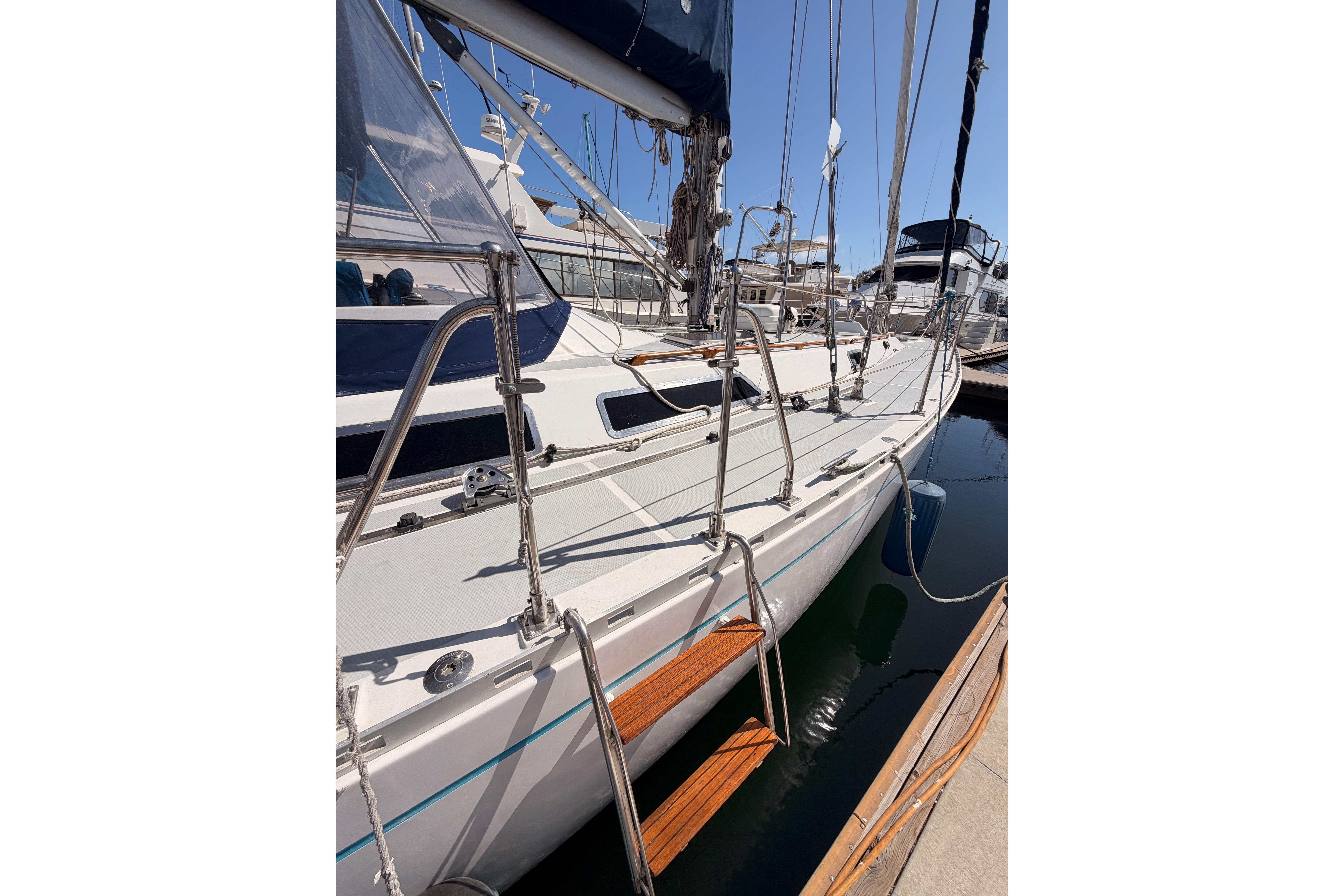 Sleek 1991 Hylas 51 sailboat docked, showcasing polished deck and rigging.