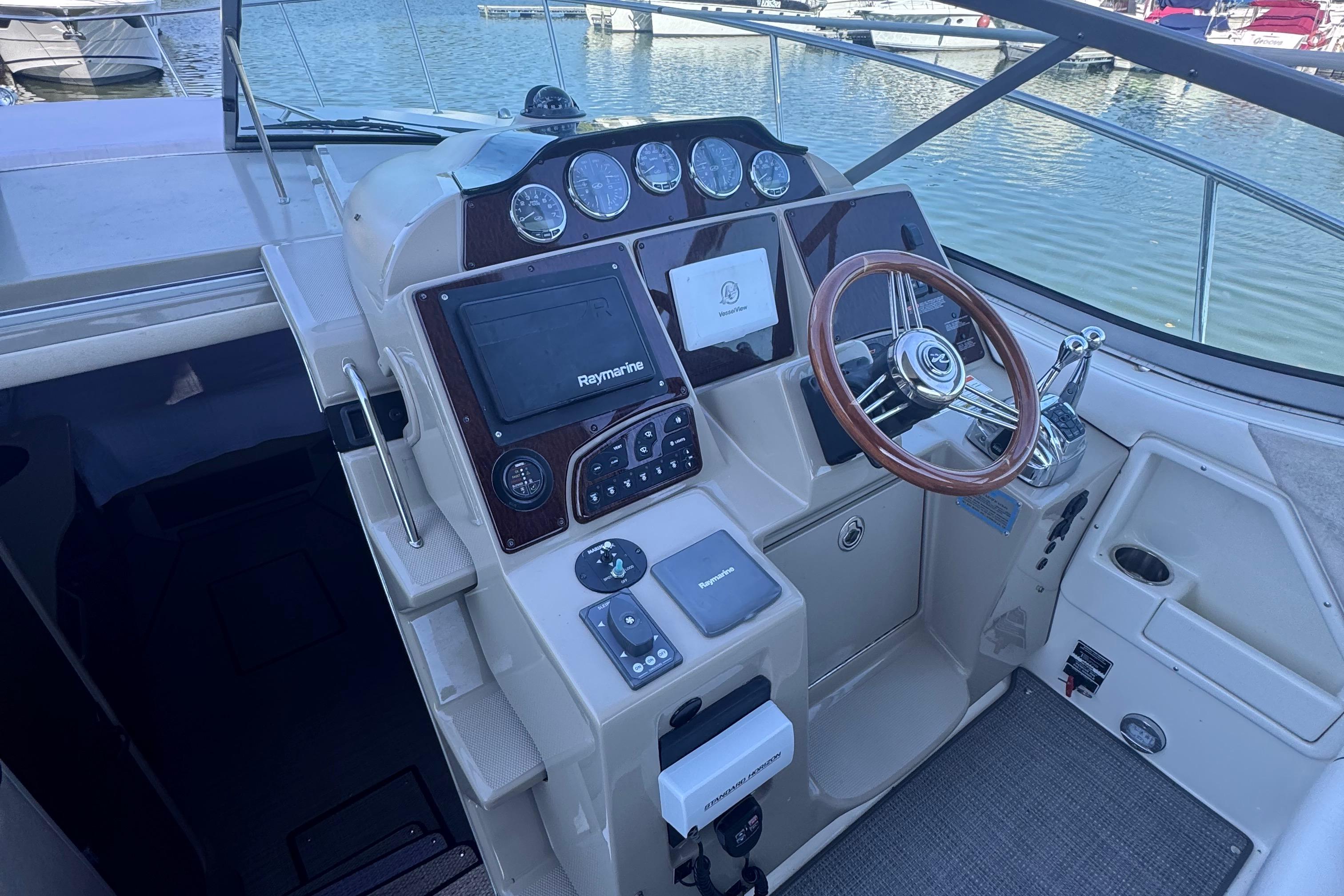 Cockpit of 2008 Sea Ray 350 Sundancer with steering wheel and navigation controls.