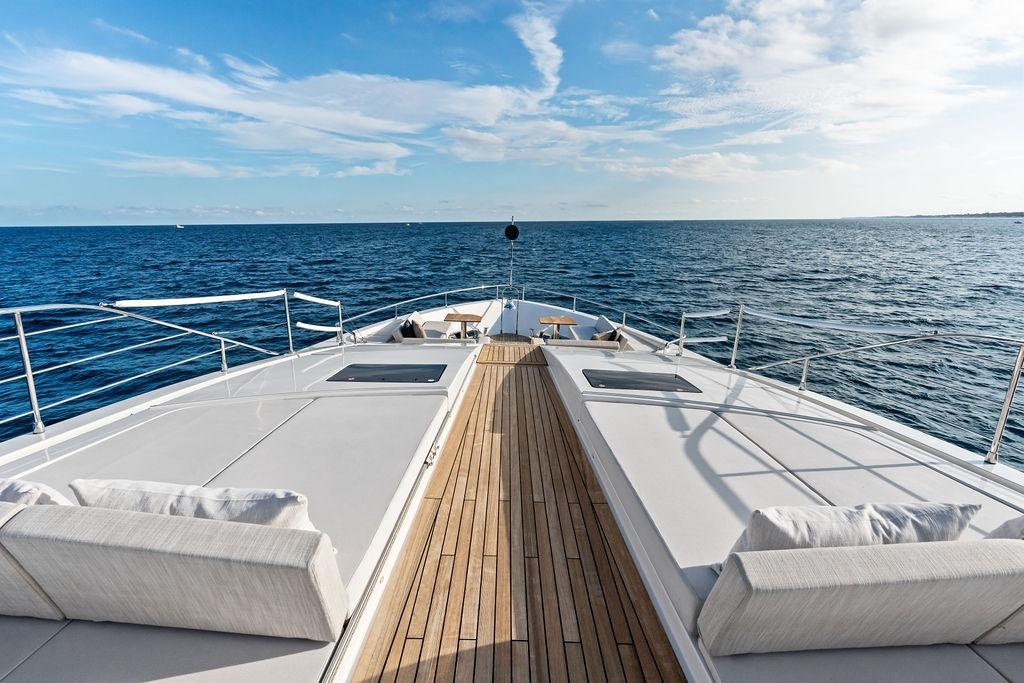 Luxurious 2018 Custom Line 120 yacht deck with ocean view and clear skies.