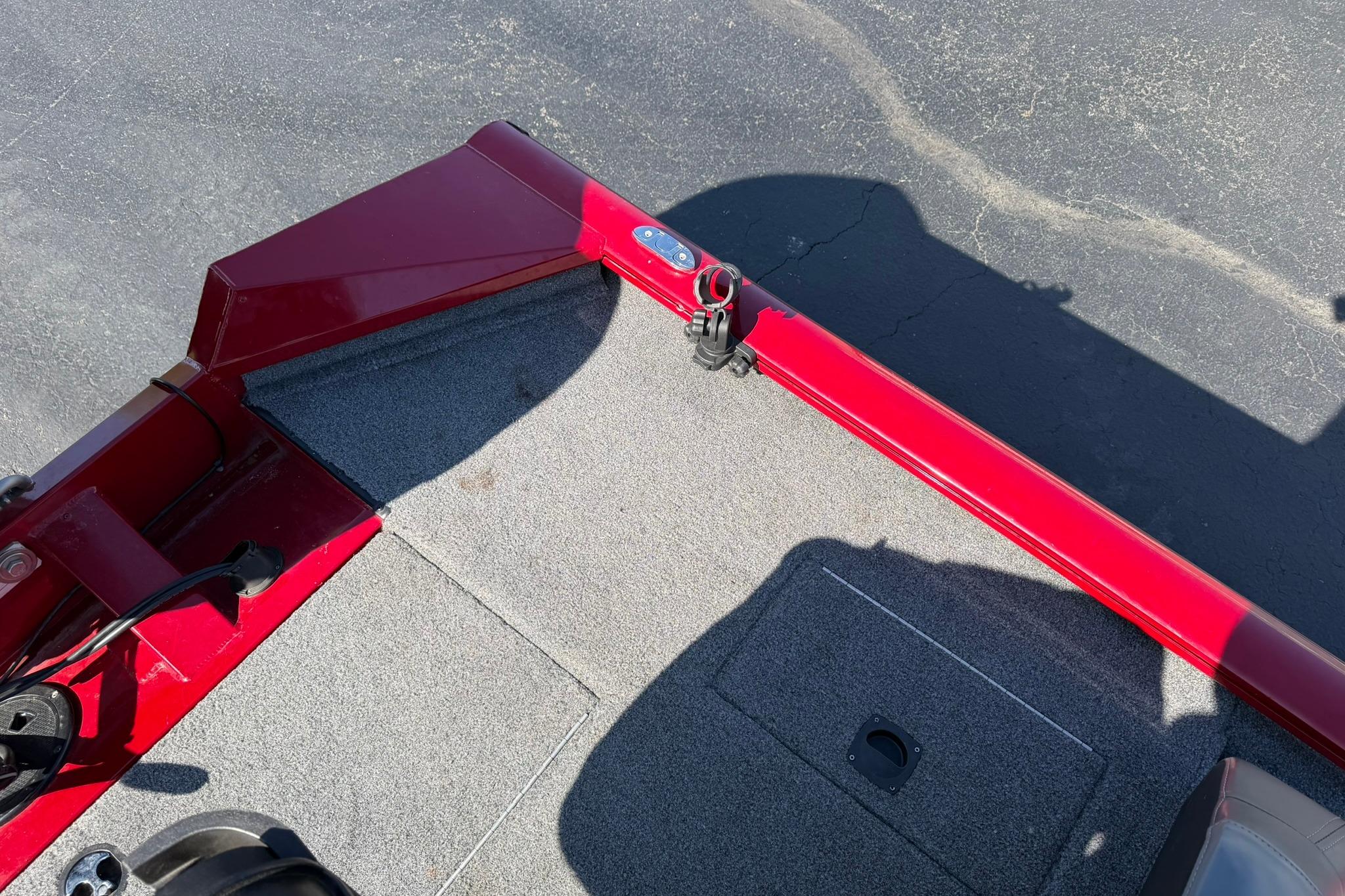 2024 Tracker Pro Team 175 TXW boat interior with red trim and gray carpet.