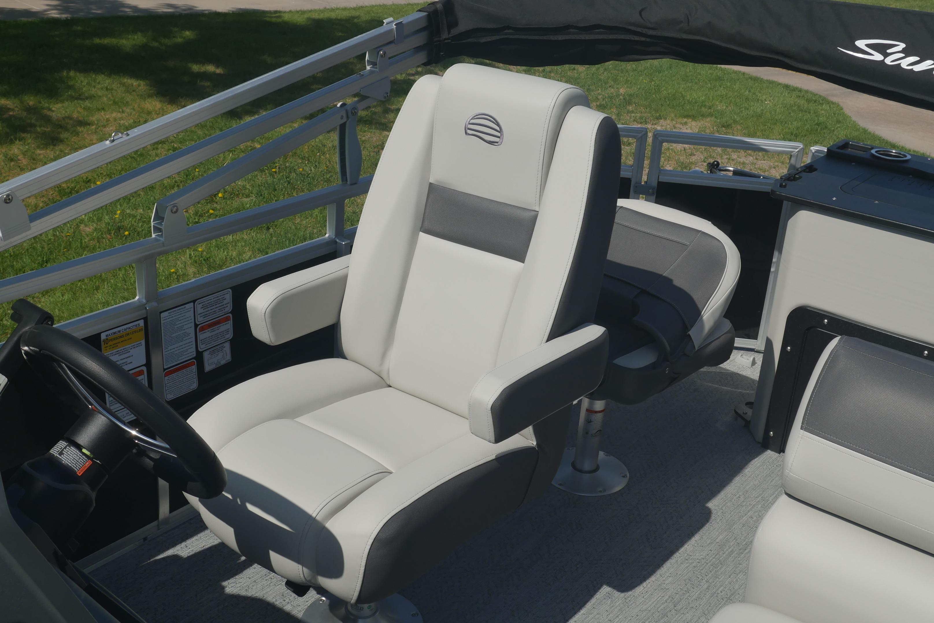 2026 Sun Tracker Fishin' Barge 20 DLX interior with comfortable seating and steering wheel.