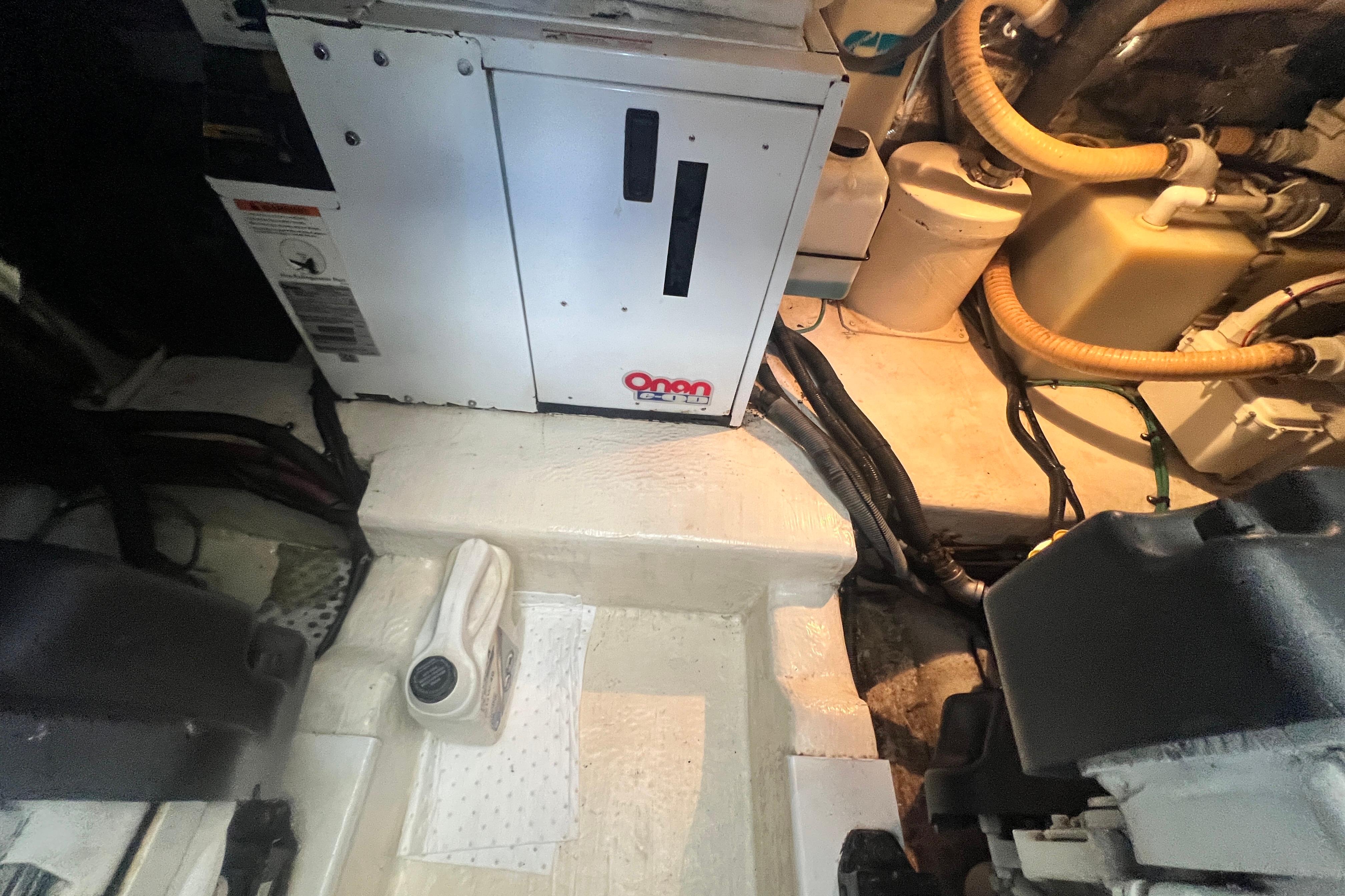 Engine room of 2007 Riviera 33 Flybridge with Onan generator and mechanical components.