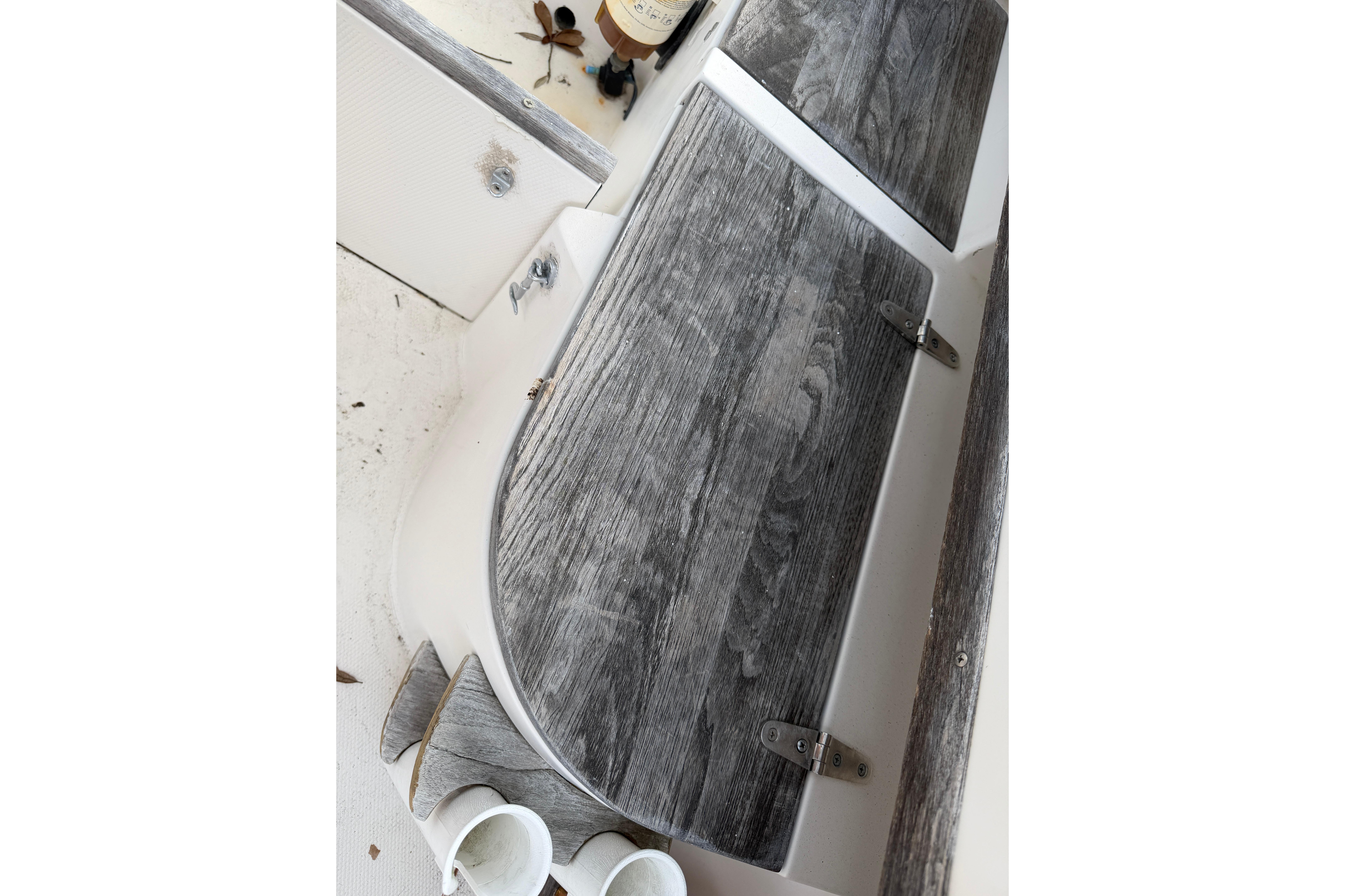 1987 Grady-White Seafarer 226 boat interior with weathered wood finish and storage compartments.