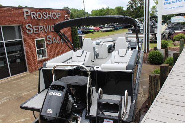 2025 Tahoe Pontoon Cascade Quad Lounger at dealership, featuring sleek design and powerful 200 HP engine.