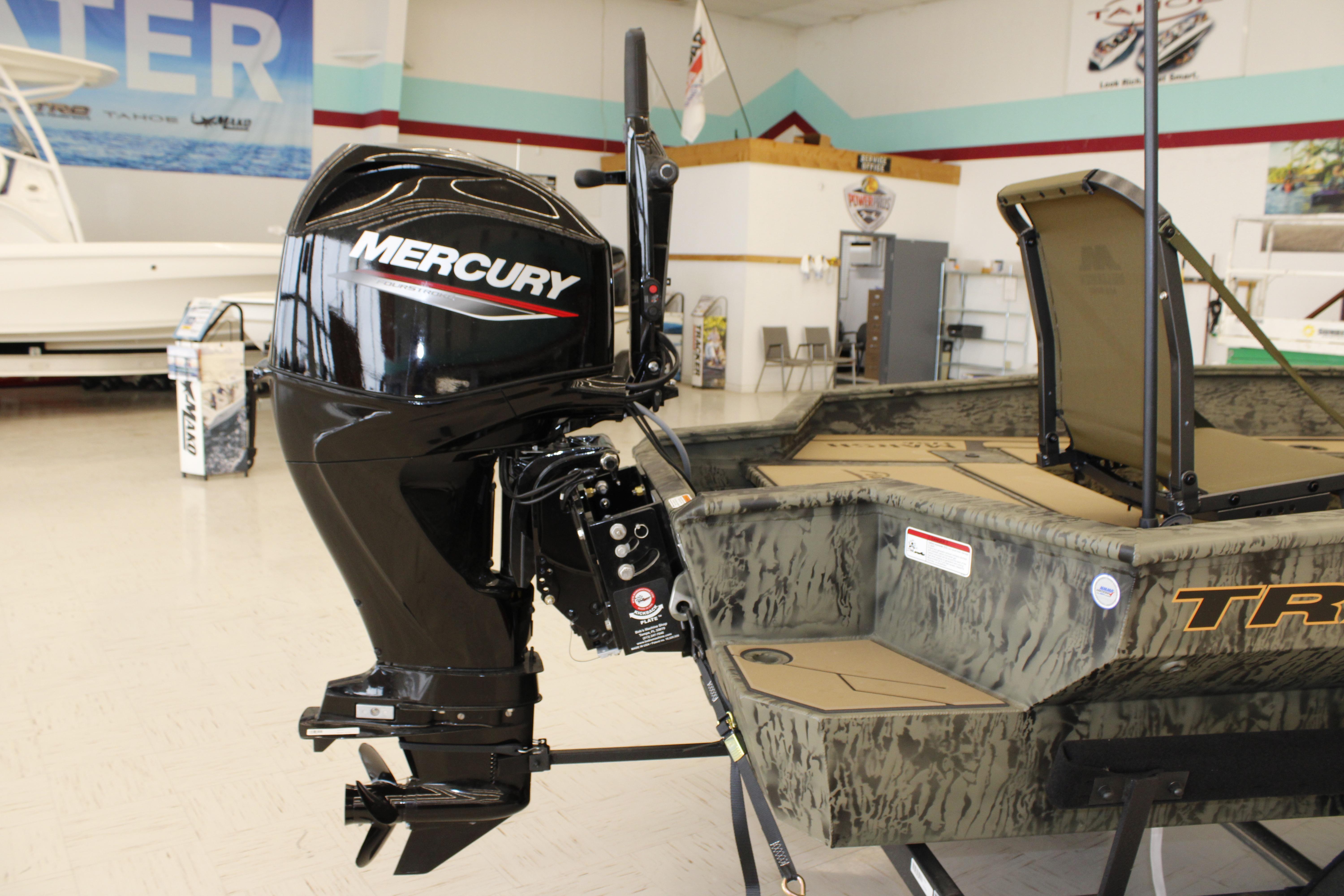 2026 Tracker Grizzly 1756 T Marsh boat with Mercury outboard motor in showroom.