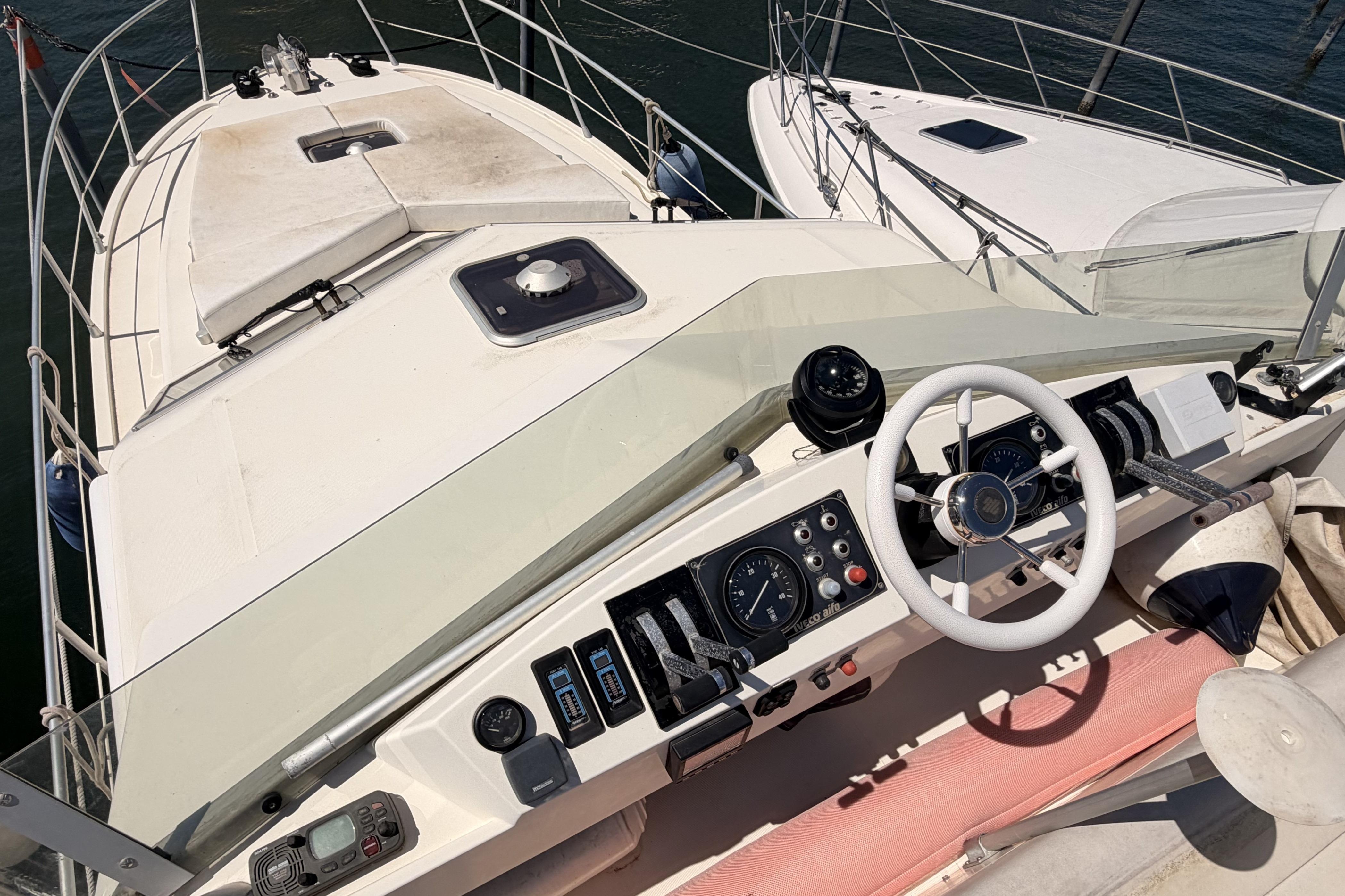 Cockpit view of a 1995 Guy Couach 1202 yacht with steering wheel and controls.