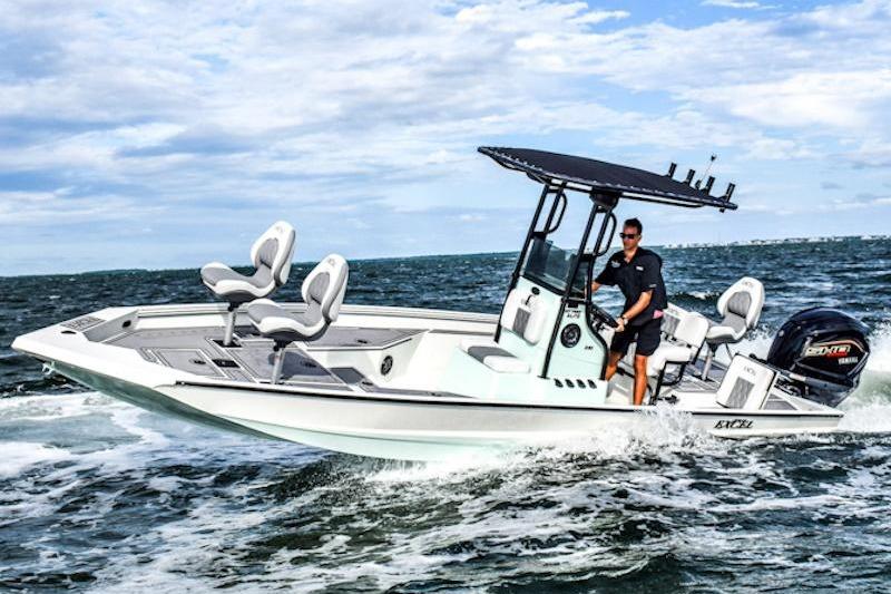 2026 Excel 230 Bay Pro Elite boat cruising on open water under a clear sky.