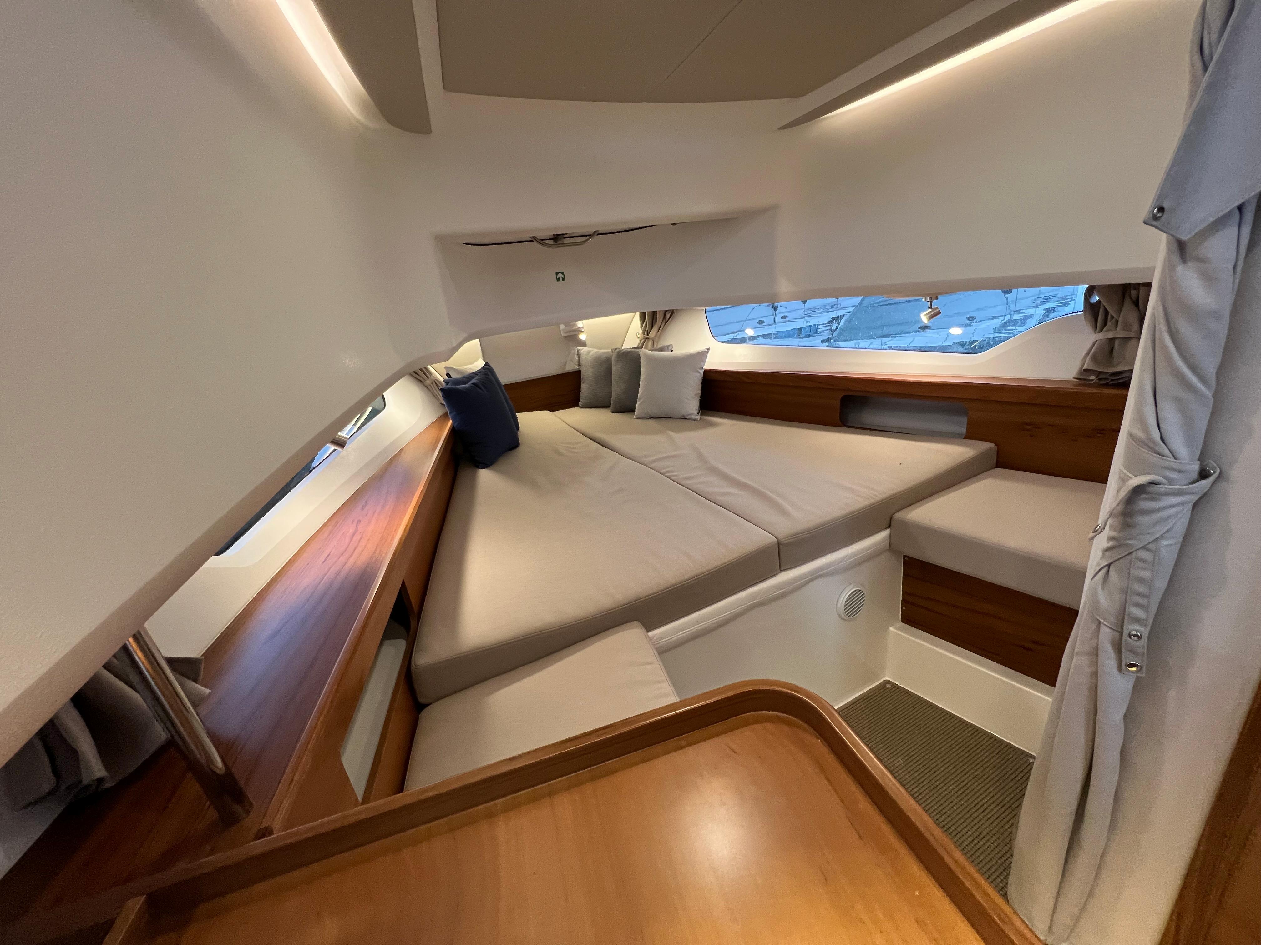 Luxurious interior of 2021 Nimbus Tender 11 boat with cozy seating and elegant wood finish.