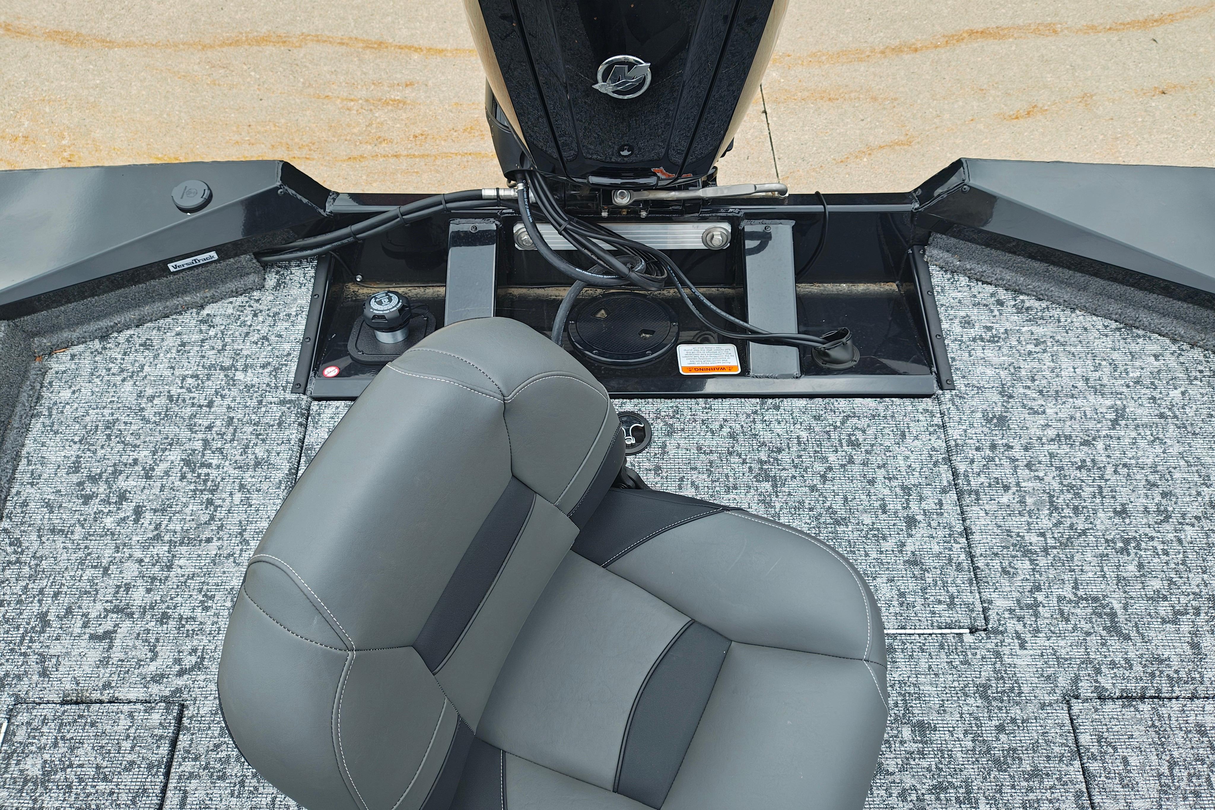 2026 Tracker Pro Team 175 boat interior with gray seating and carpeted flooring.