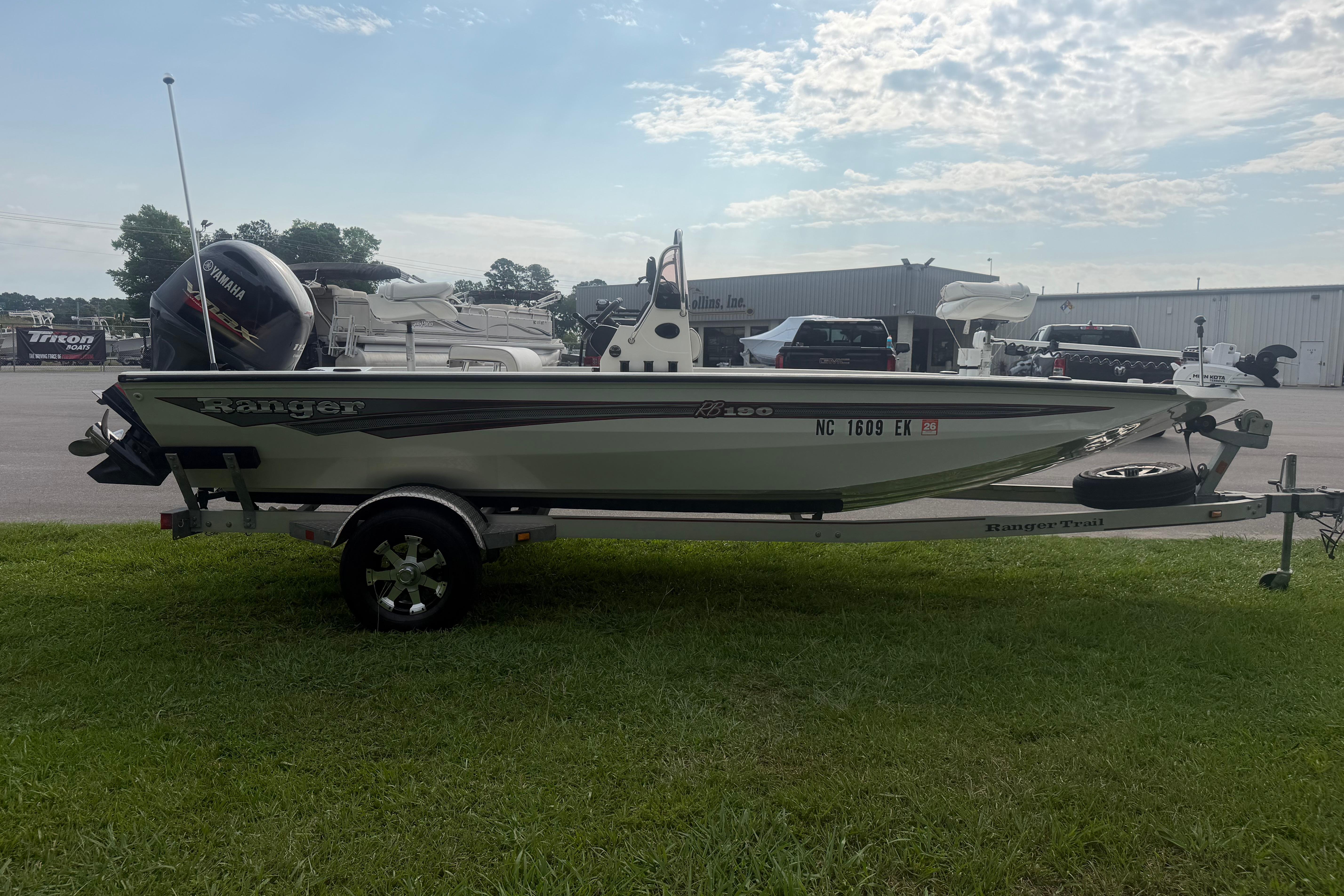 2018 Ranger RB190 boat on trailer, parked on grass, with Yamaha outboard motor.