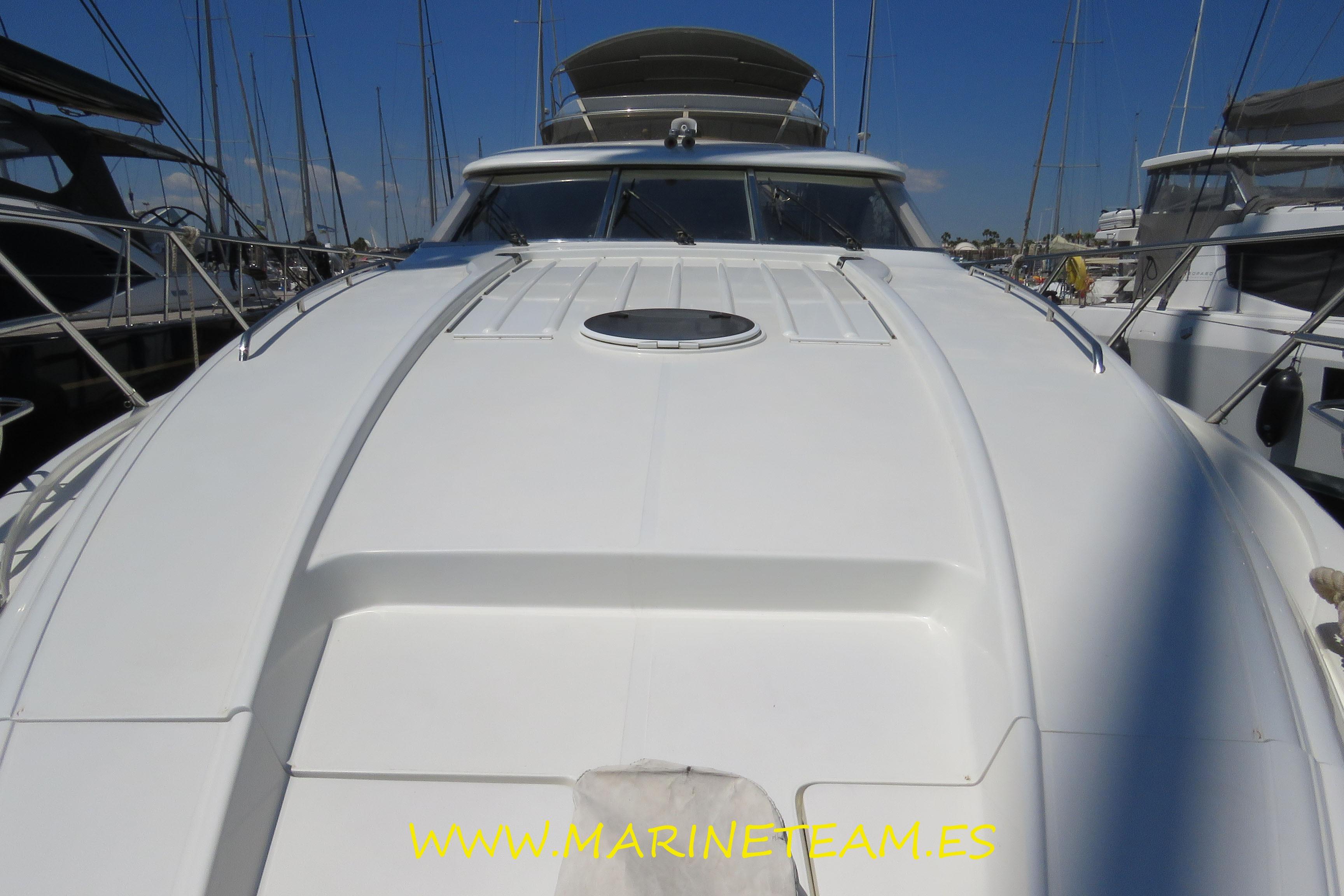 1995 Princess 60 yacht docked at marina, showcasing sleek white deck design.