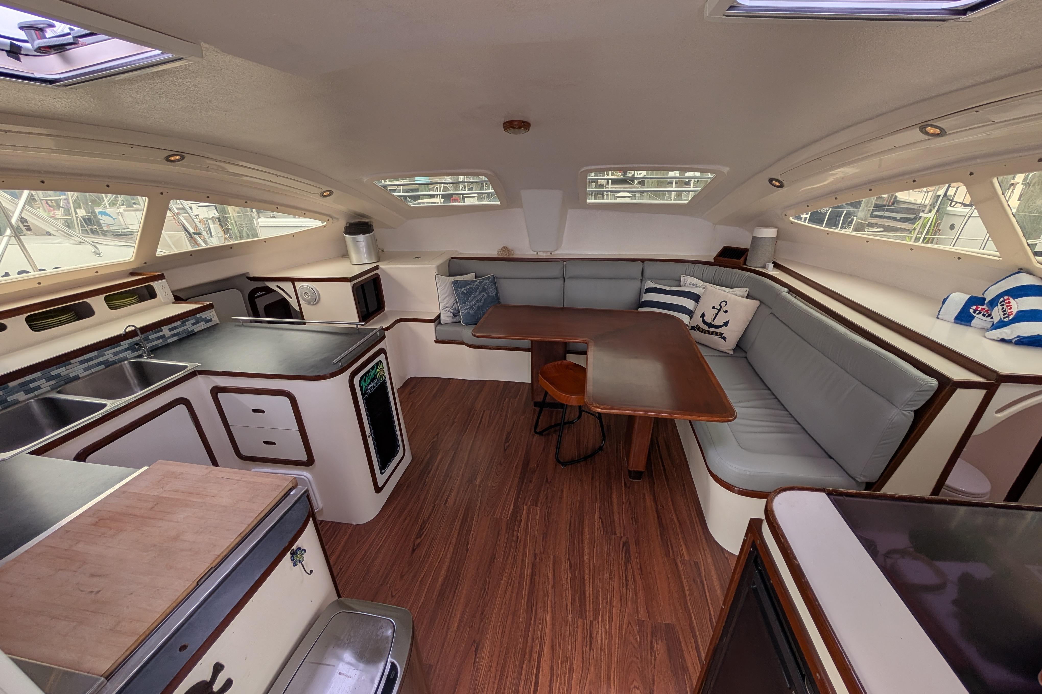 Spacious interior of 1999 Island Spirit 37 yacht with modern kitchen and cozy seating area.