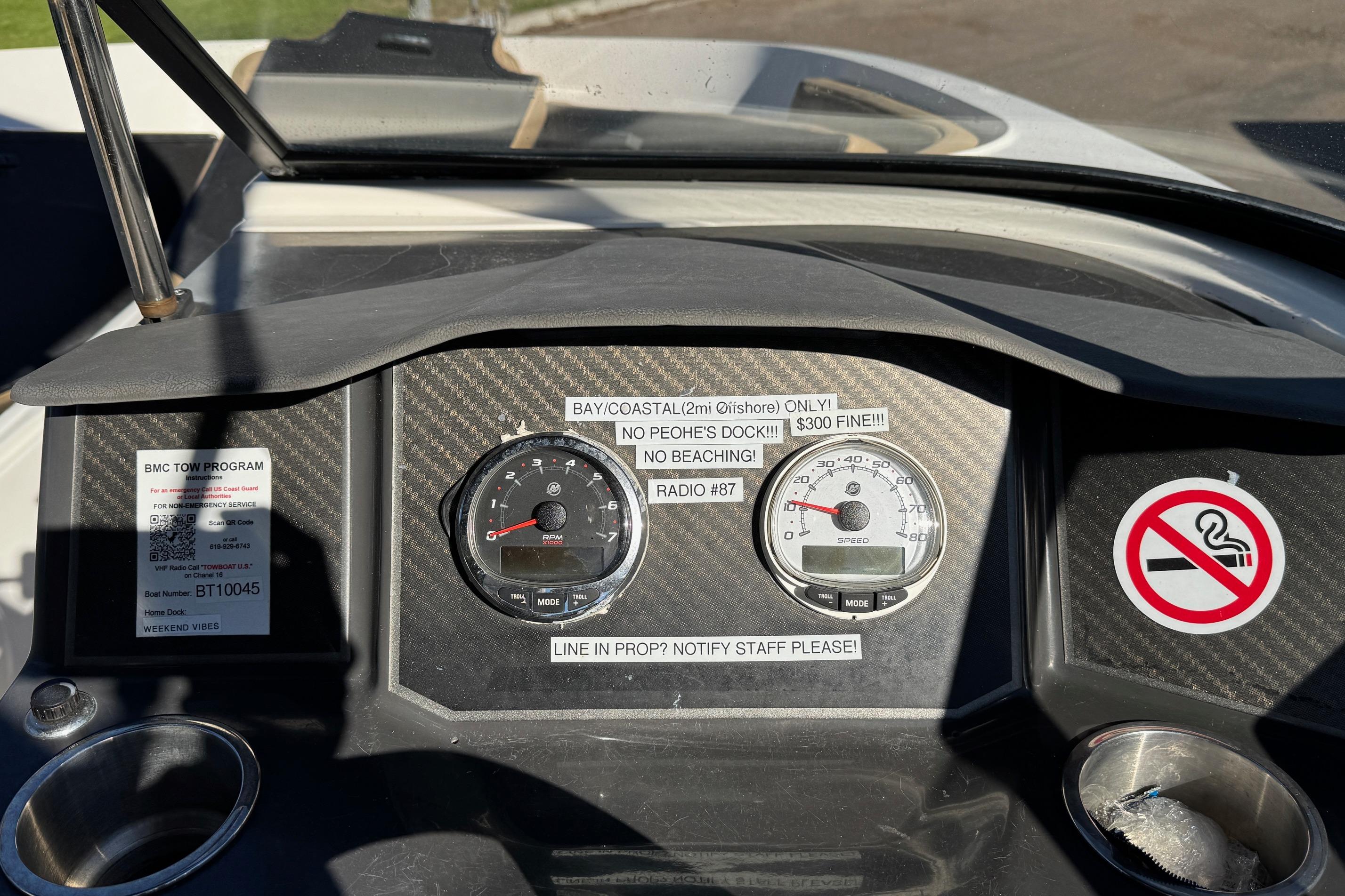 Dashboard of a 2022 Bayliner VR6 Bowrider OB with gauges and warning labels.