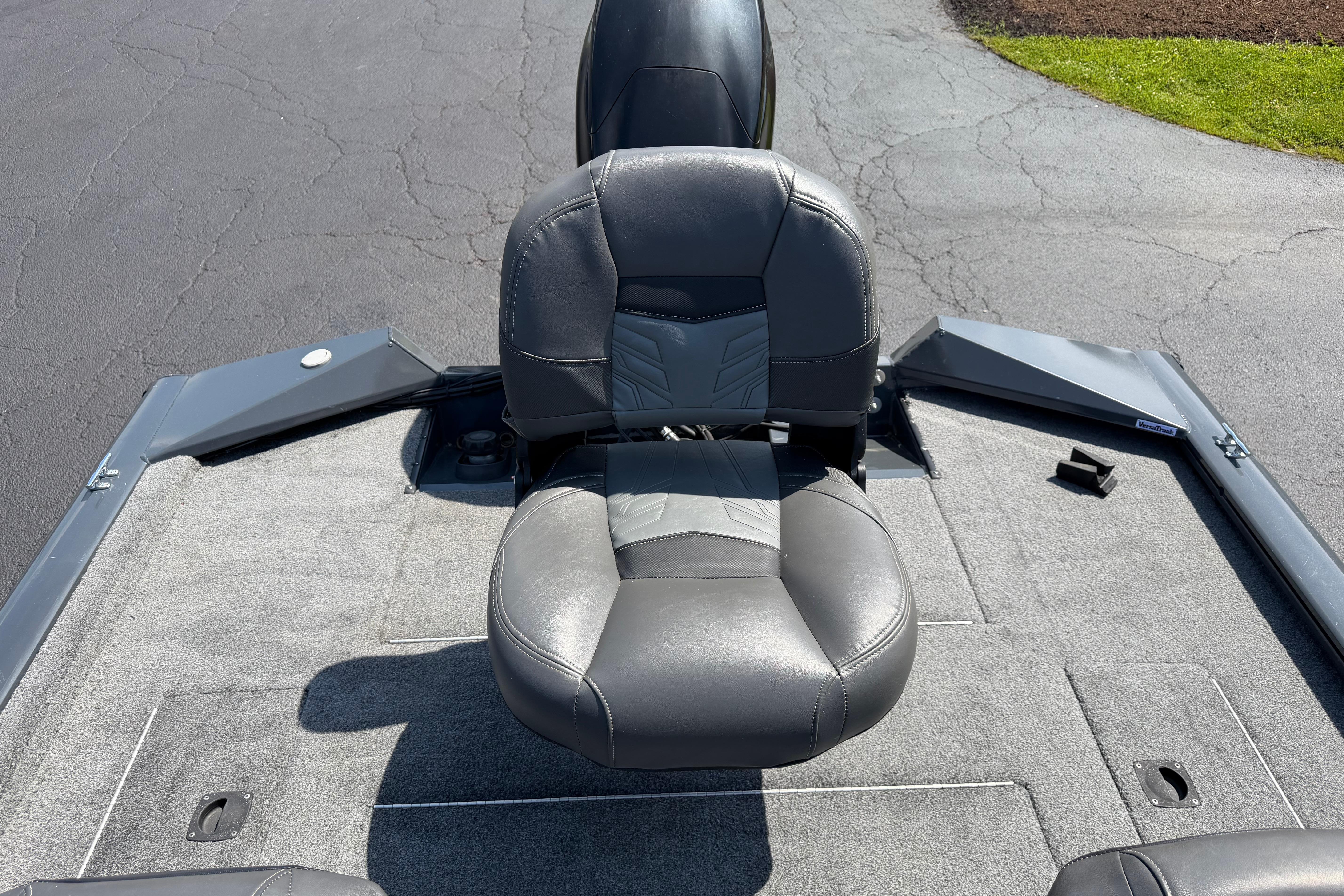 2019 Tracker Pro Team 175 TF boat seat on a carpeted deck.