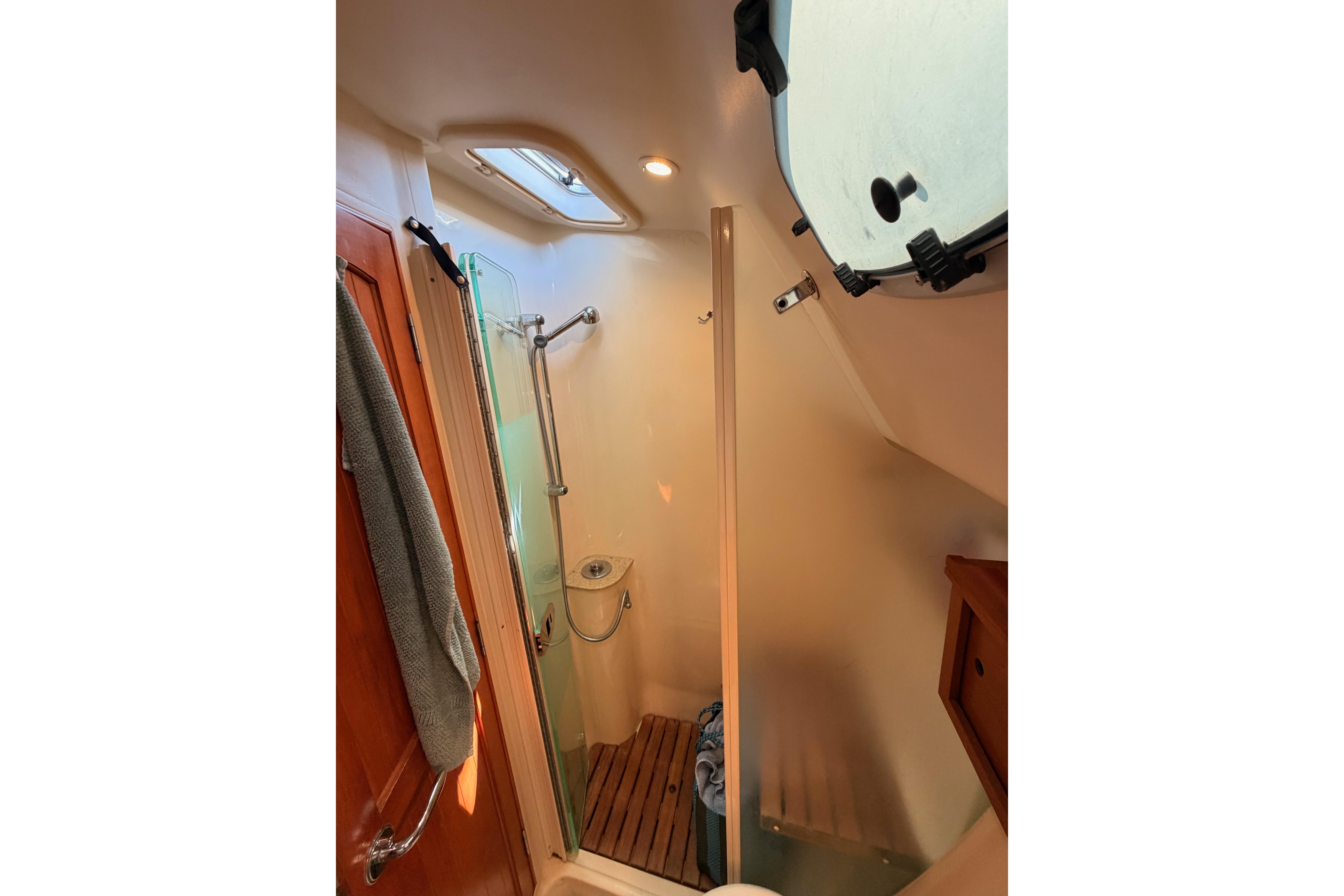 Bathroom interior of 2008 Hunter 45 Deck Salon yacht, featuring shower and wooden accents.