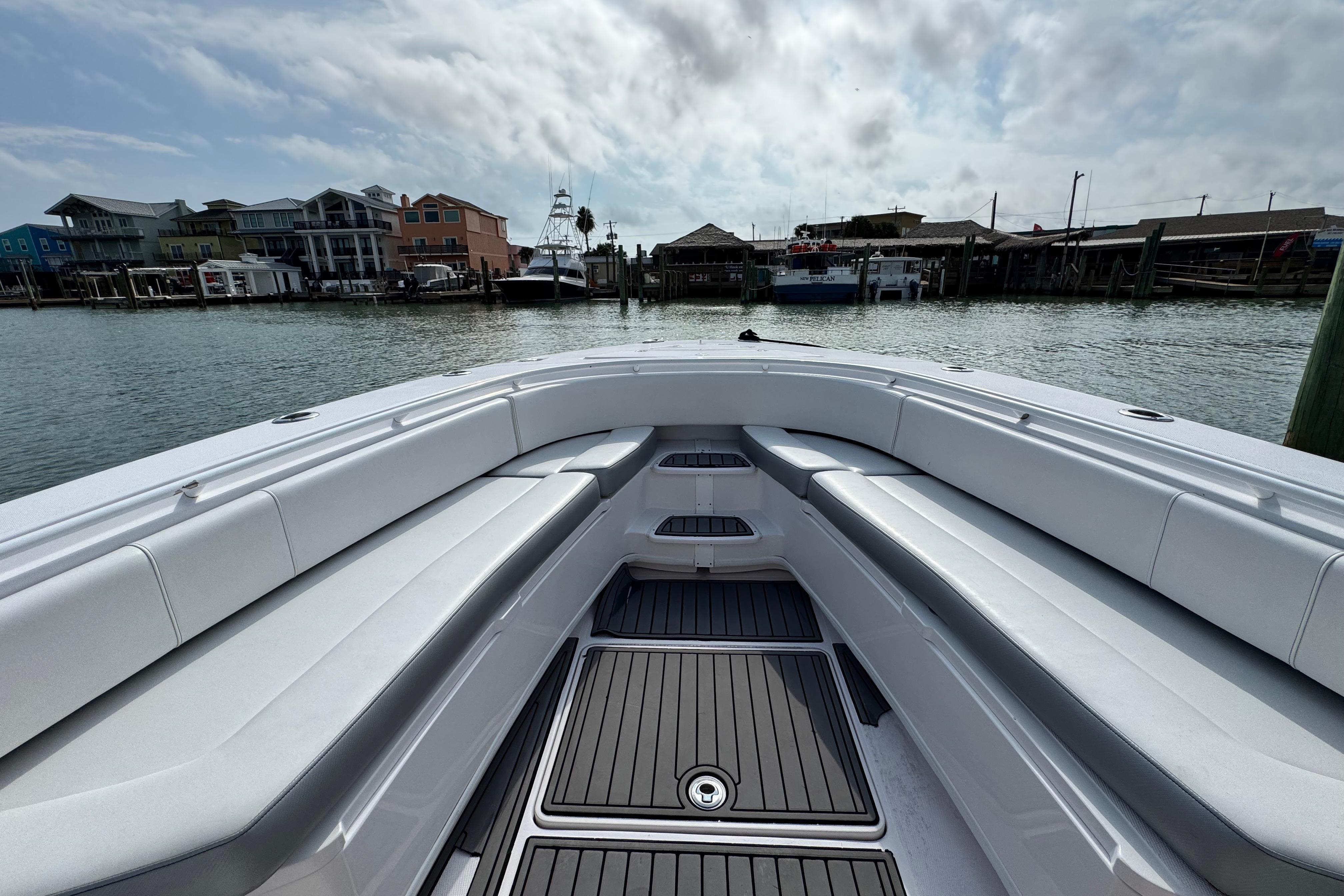 2018 Fountain 34 Center Console boat docked, featuring spacious seating and sleek design.
