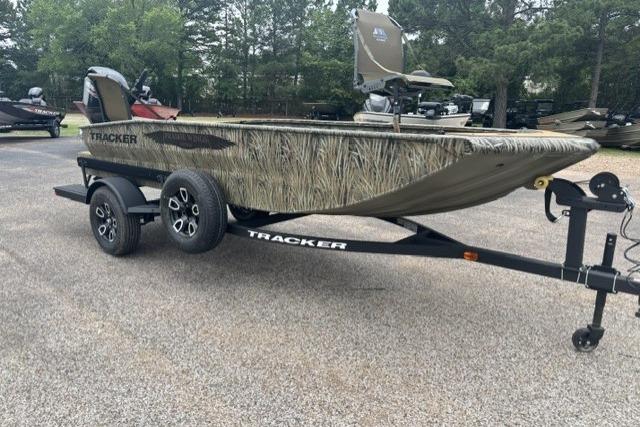 2026 Tracker Grizzly 1650 T Prairie Wings Edition boat on trailer, camo design, parked outdoors.