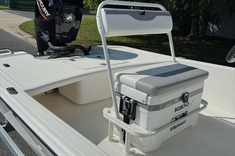 2026 Mako Pro Skiff 17 CC boat interior with Igloo cooler seat and Mercury engine.