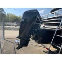 2025 Ranger Reata 223FC boat engine, black, parked outdoors near a fence.