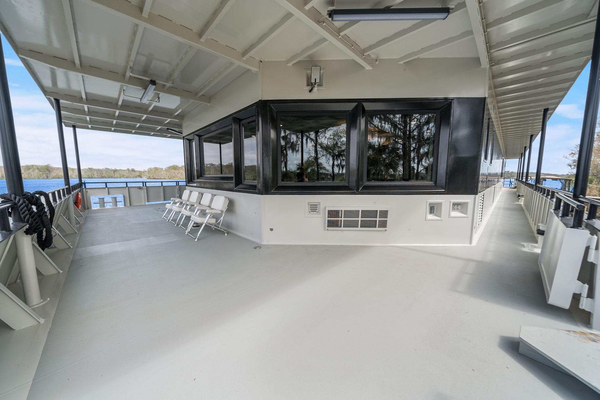 Spacious deck of 2025 Breaux Brothers 120 GLV boat with seating and scenic views.