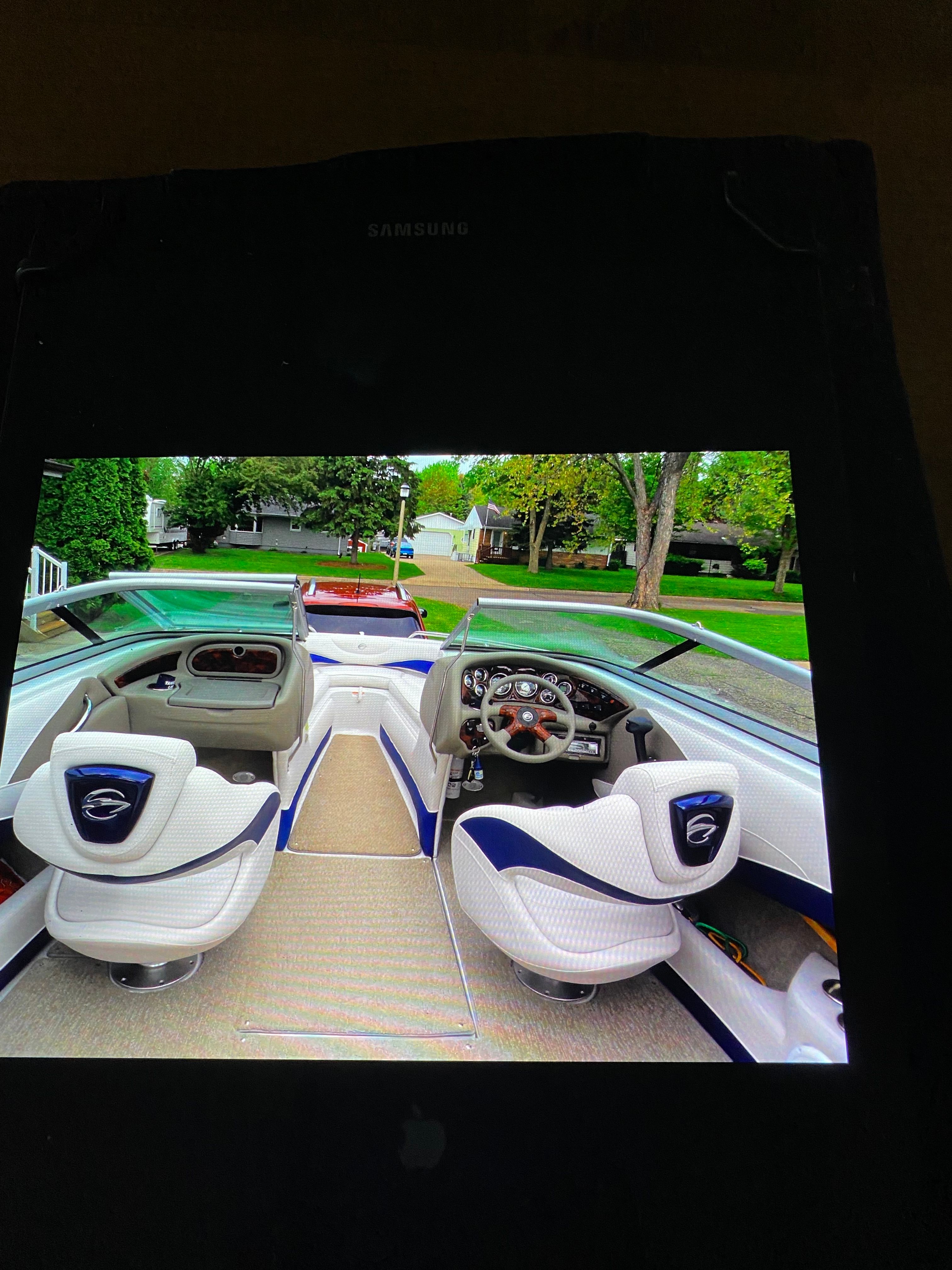Interior view of a Crownline 21 bowrider boat with white seats and a modern dashboard.