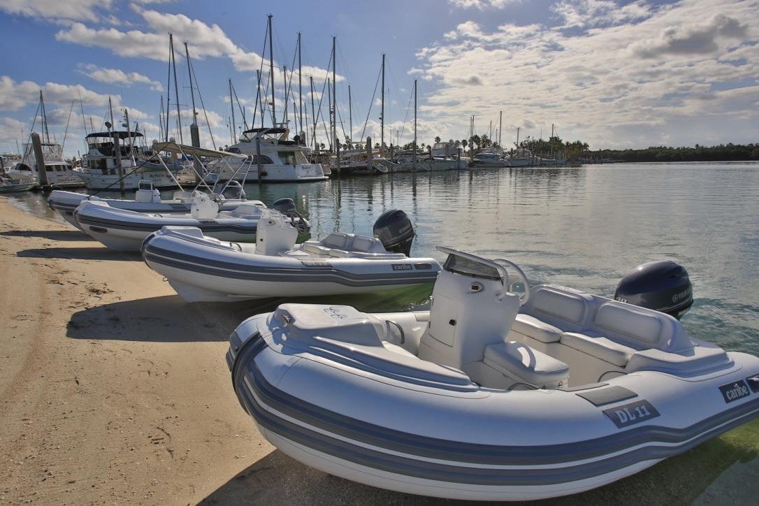 Inflatable Caribe DL11 boats docked on a sunny marina, 2025 model.