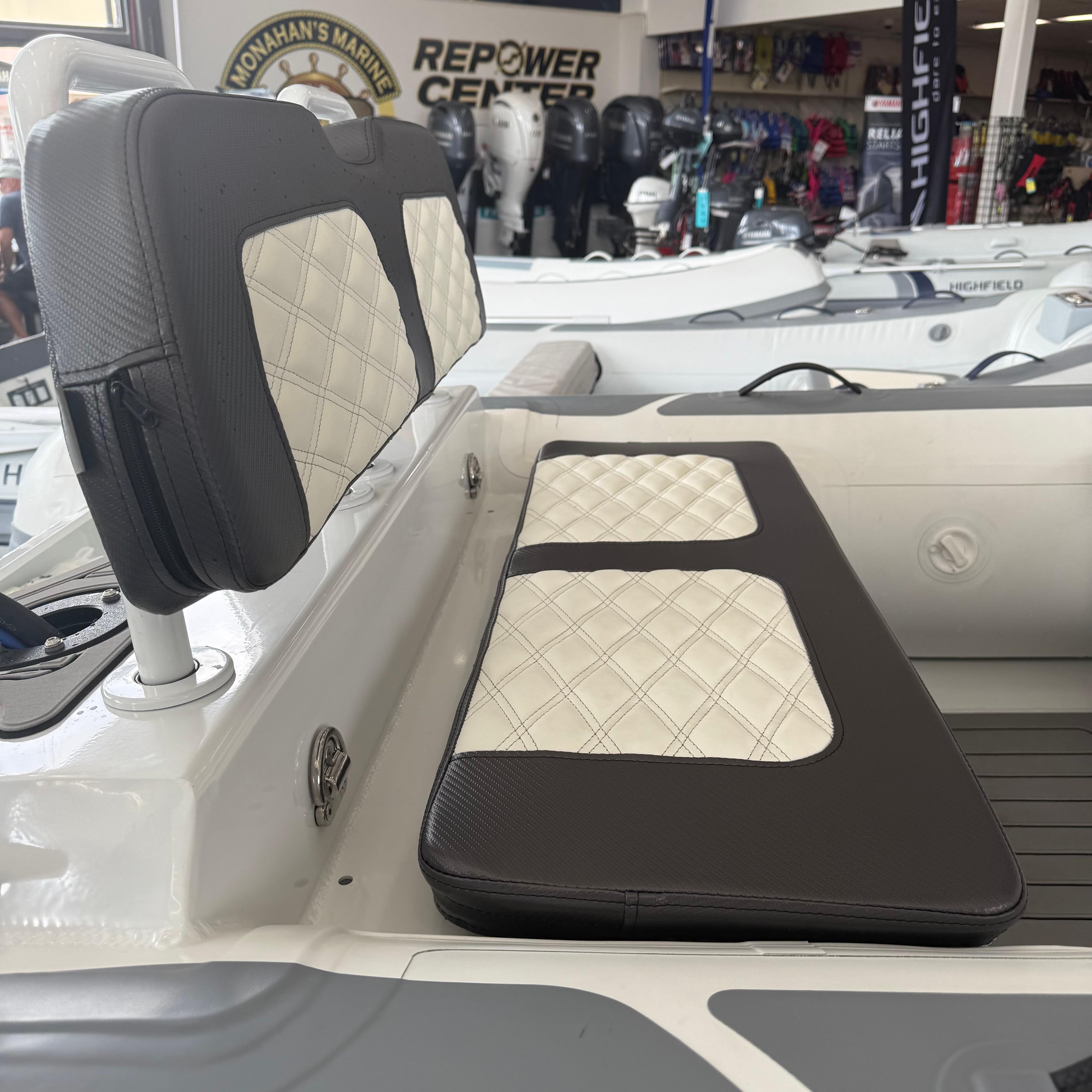 2025 Highfield Sport 360 boat interior with quilted seating in showroom.