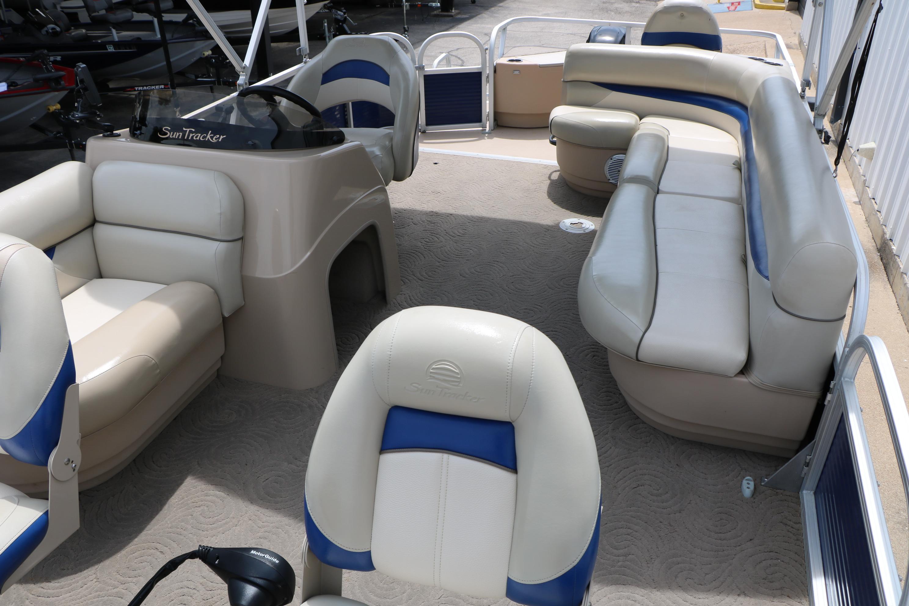 2013 Sun Tracker Fishin' Barge 20 DLX interior with beige and blue seating.