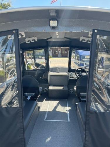 Interior view of 2024 Spartan 220 Maximus boat, featuring spacious seating and modern controls.