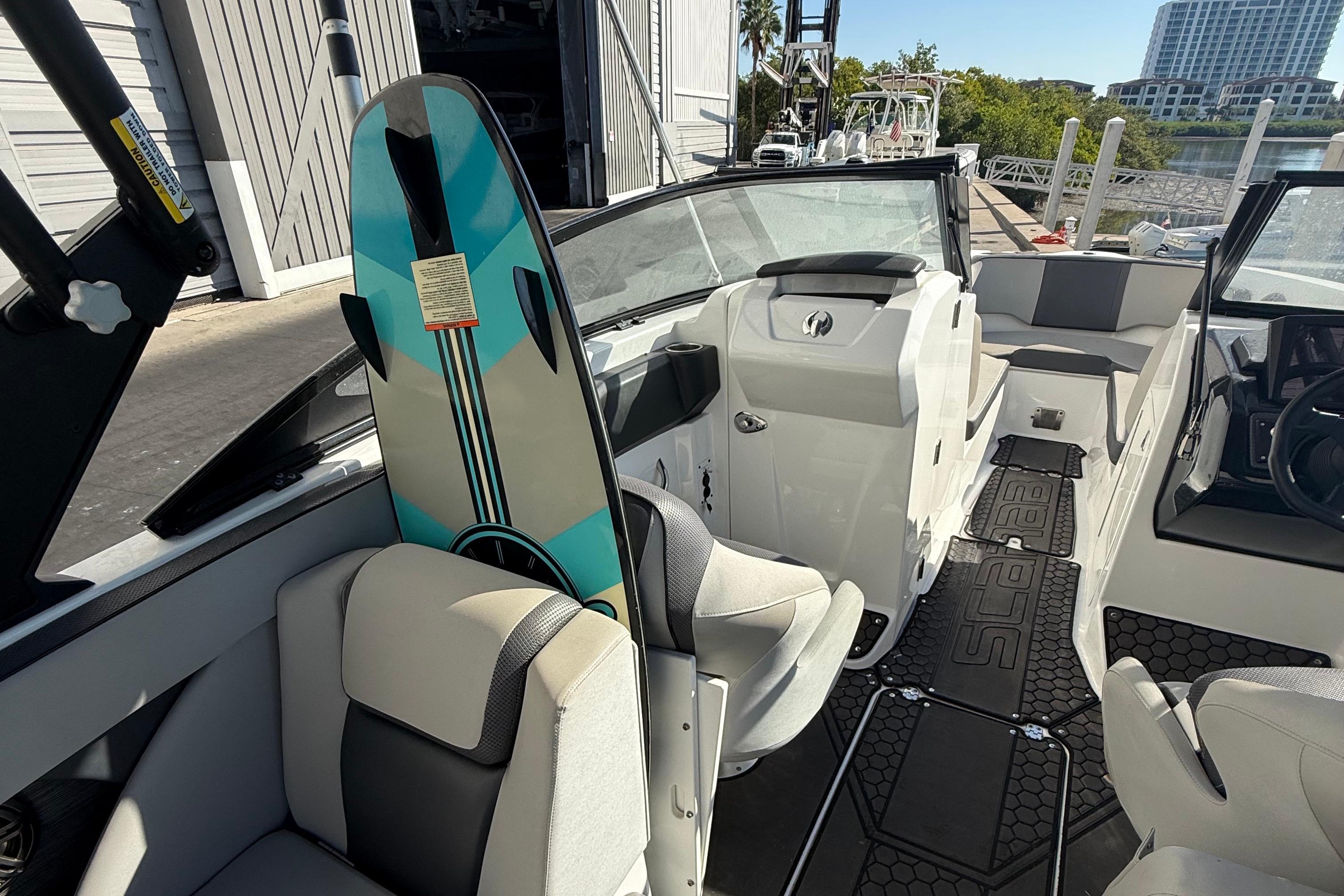 2021 Scarab 255 ID boat interior with wakeboard, featuring modern seating and design.