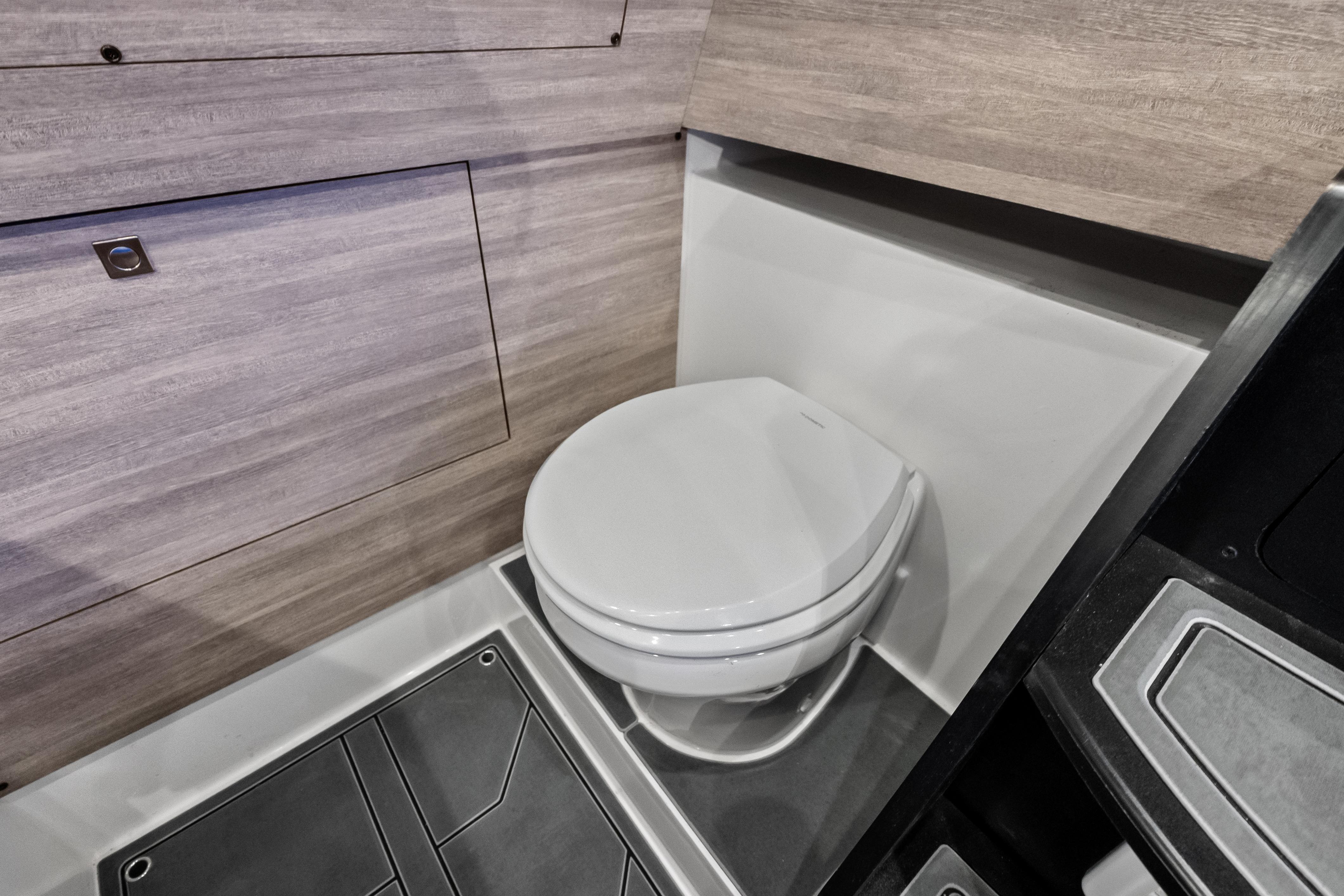 Interior of 2027 Mystic Powerboats M4200 featuring a modern marine toilet.