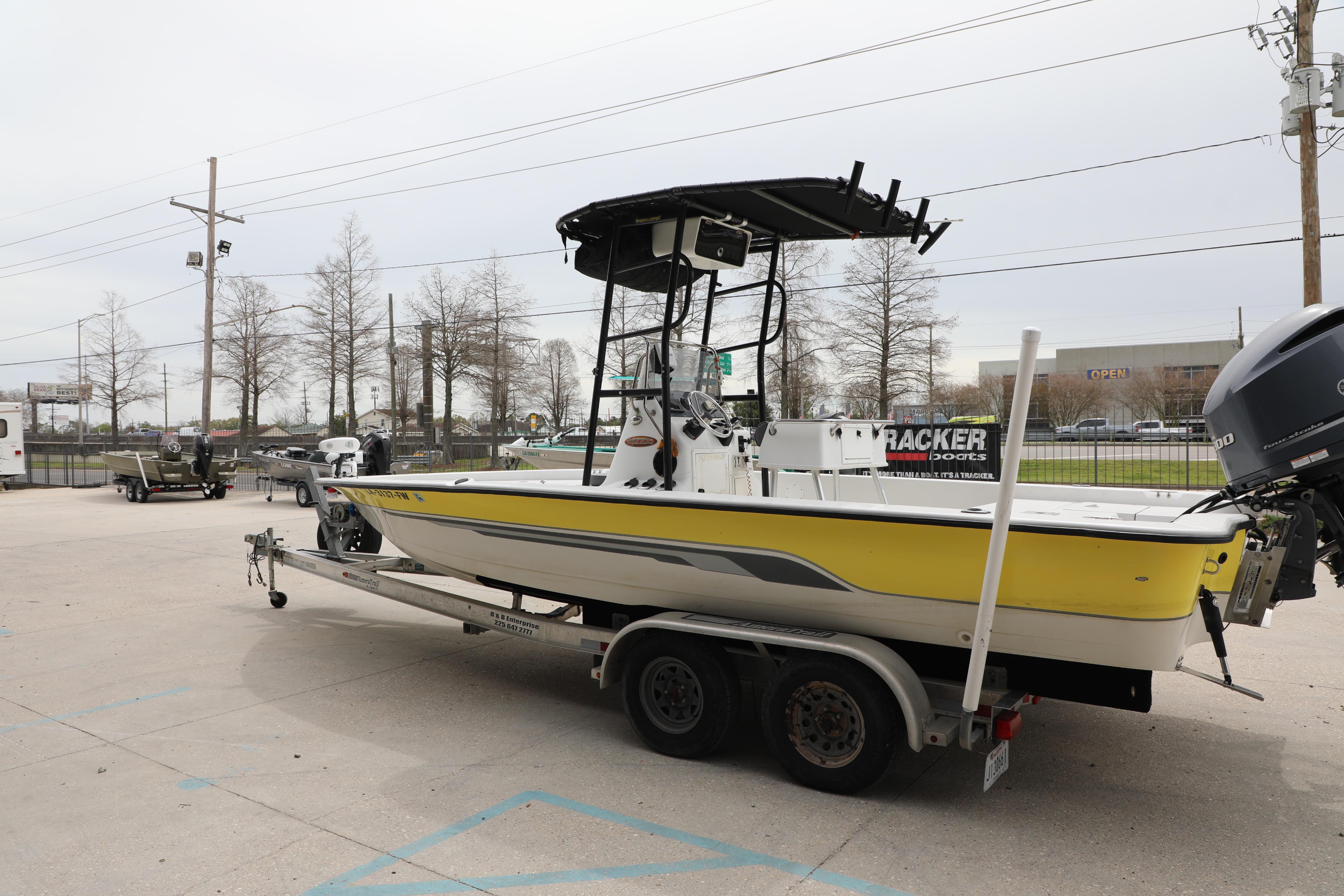 2002 Ranger 2300 Bay Ranger boat on trailer in parking lot.