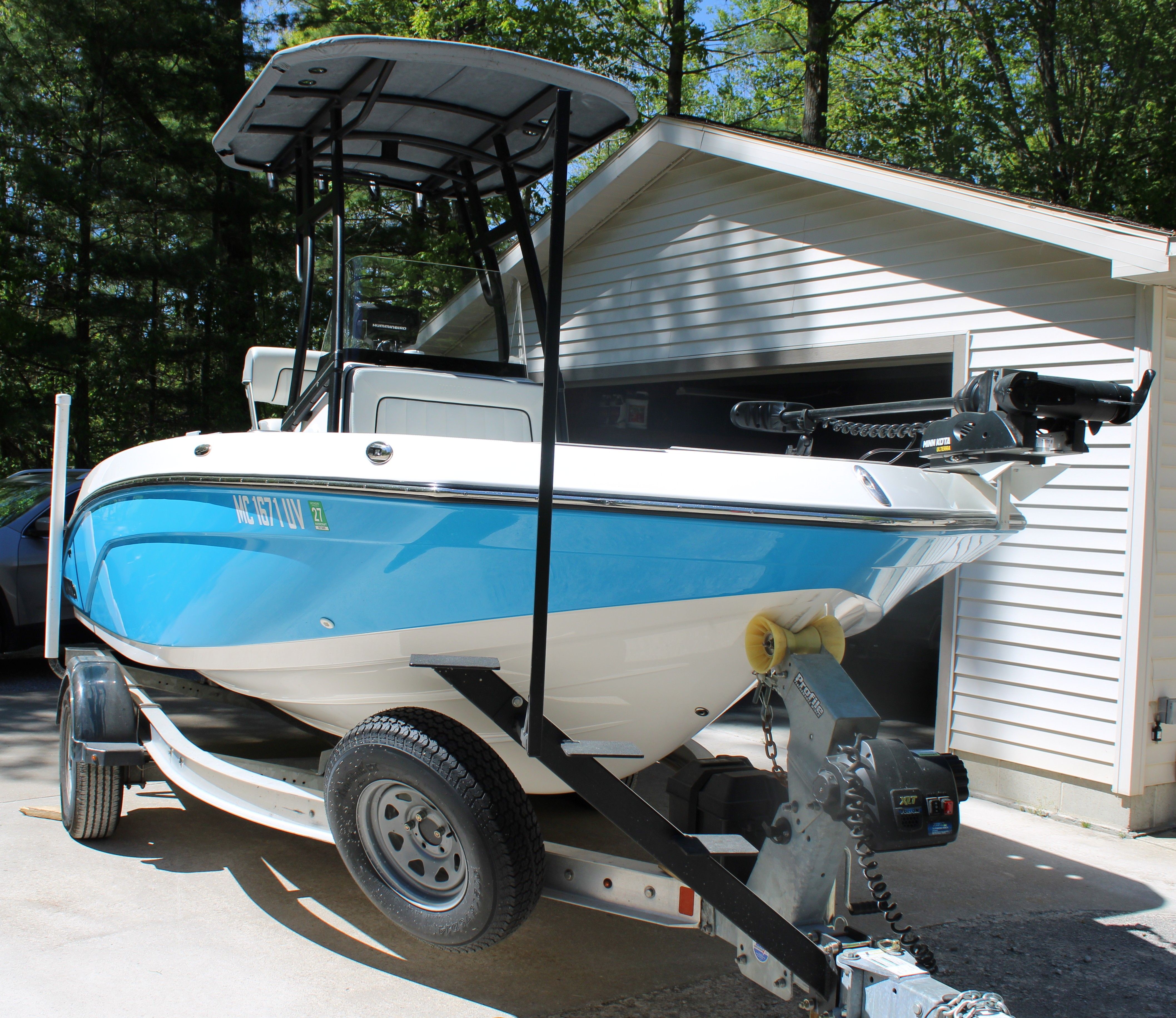 Yamaha Boats 190 FSH Sport 2022 on a trailer in front of a garage.