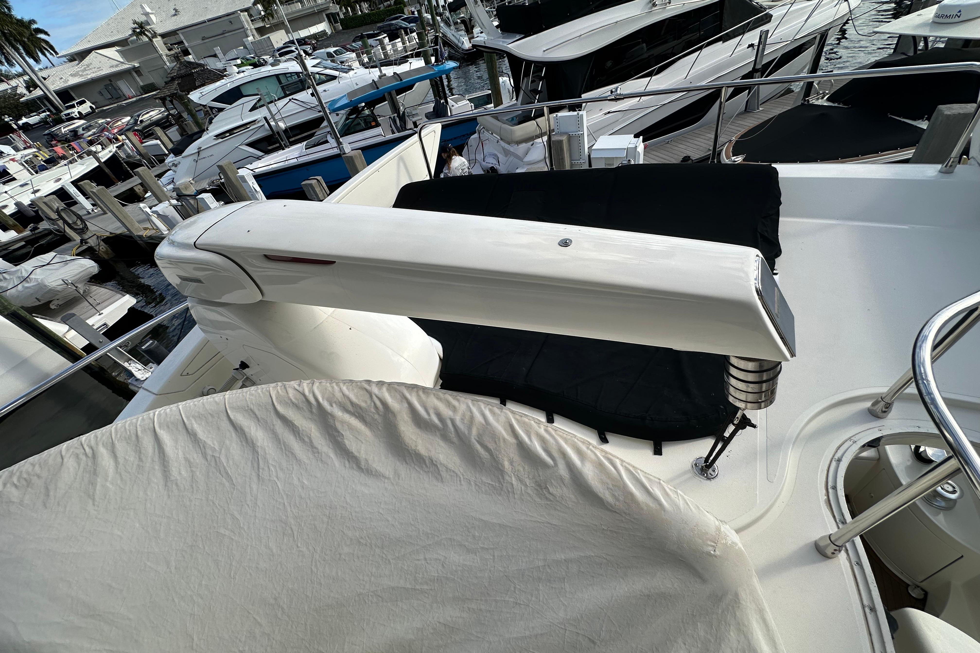 2004 Azimut 55E yacht deck with covered equipment at marina.