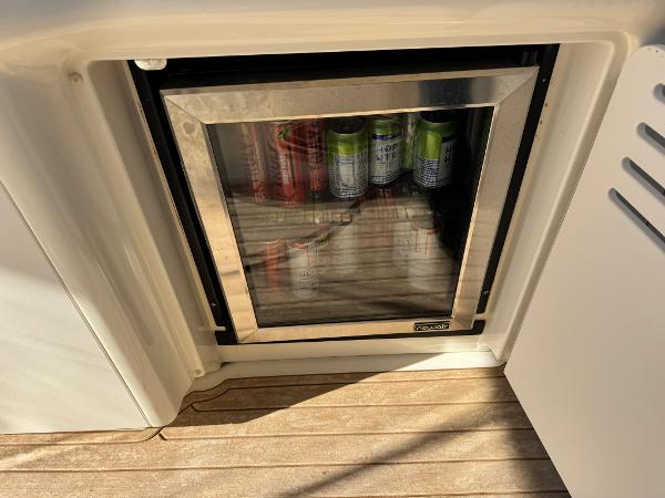 Mini fridge stocked with beverages on a 2004 Sea Ray 390 Sundancer yacht.