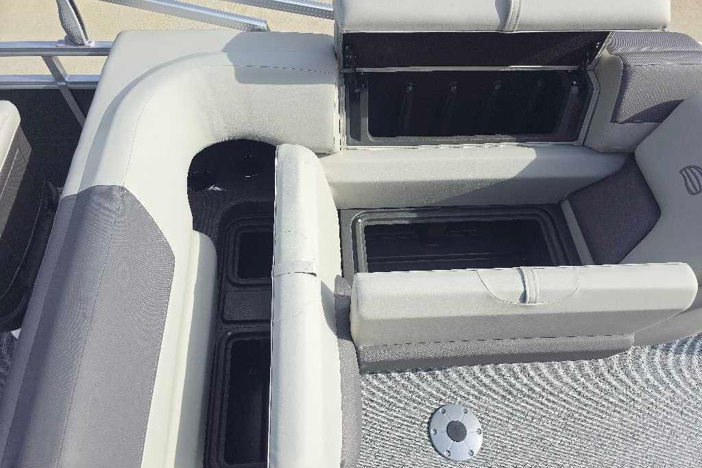 Interior seating and storage of 2026 Sun Tracker Fishin' Barge 20 DLX pontoon boat.