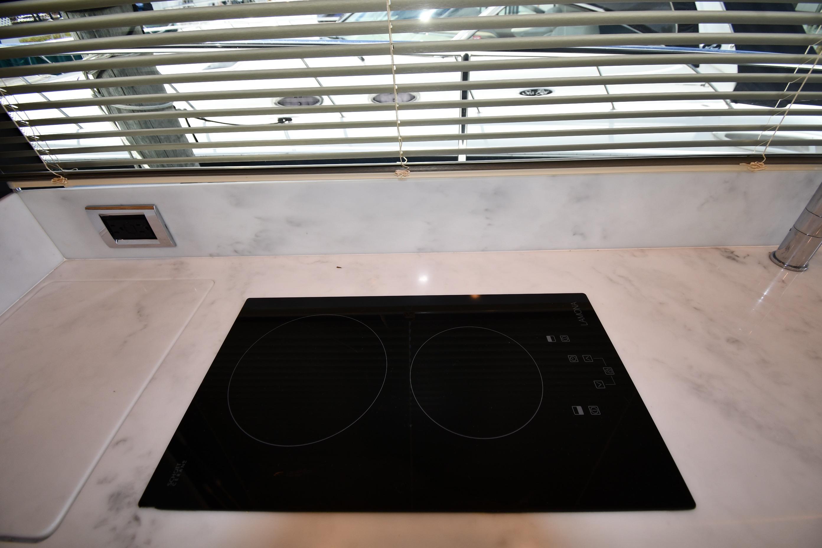Modern kitchen countertop with induction cooktop on 2024 Fairline G50 Targa yacht.
