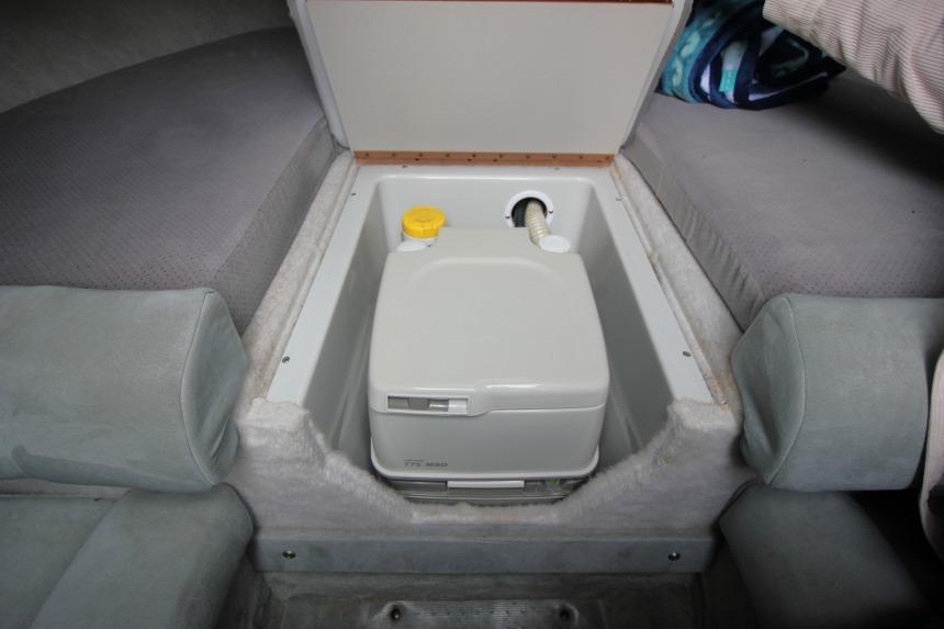 1989 Formula 223 SS boat interior with built-in portable toilet compartment.