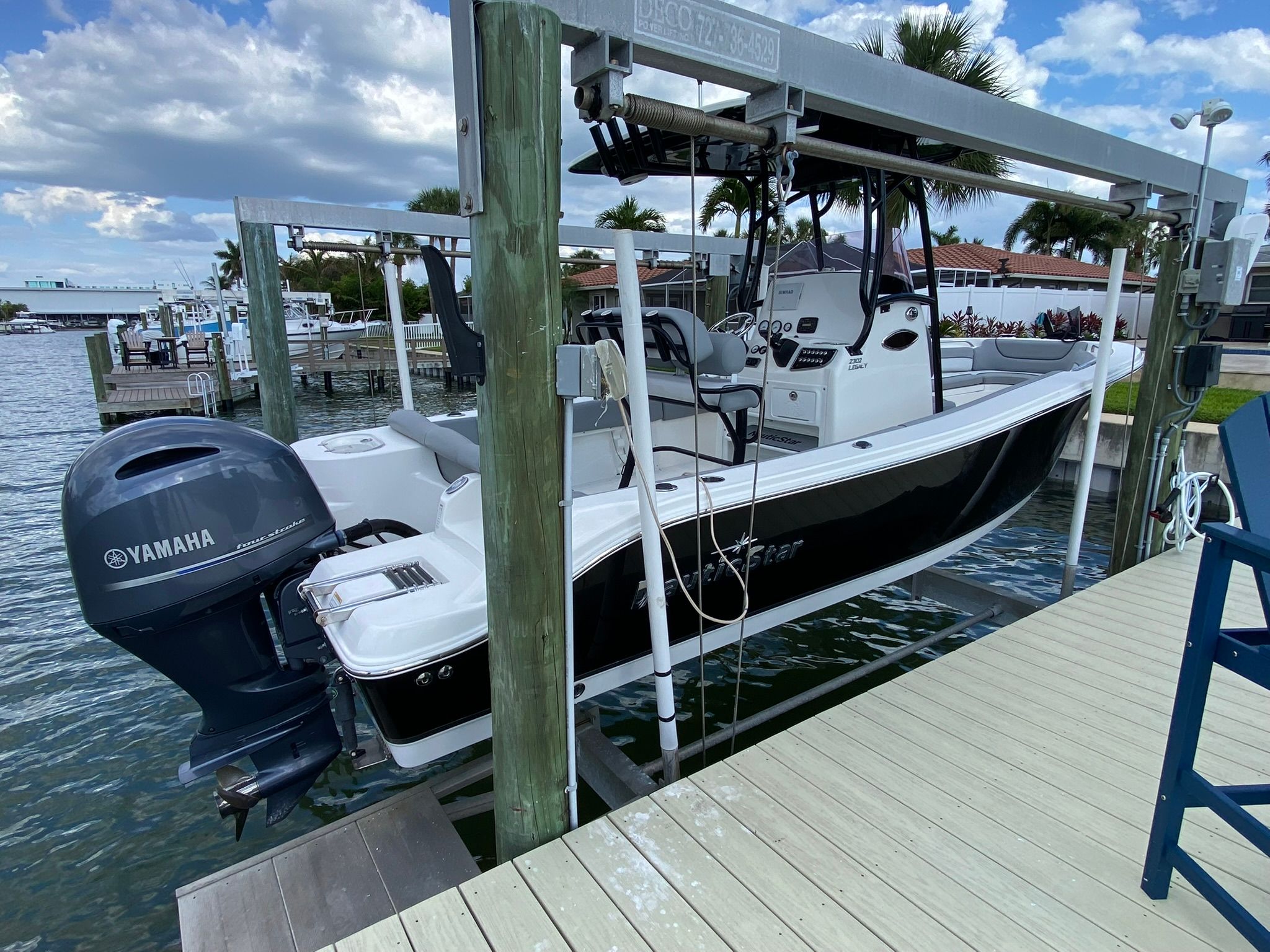 2021 NauticStar Legacy boat on a lift by the water.