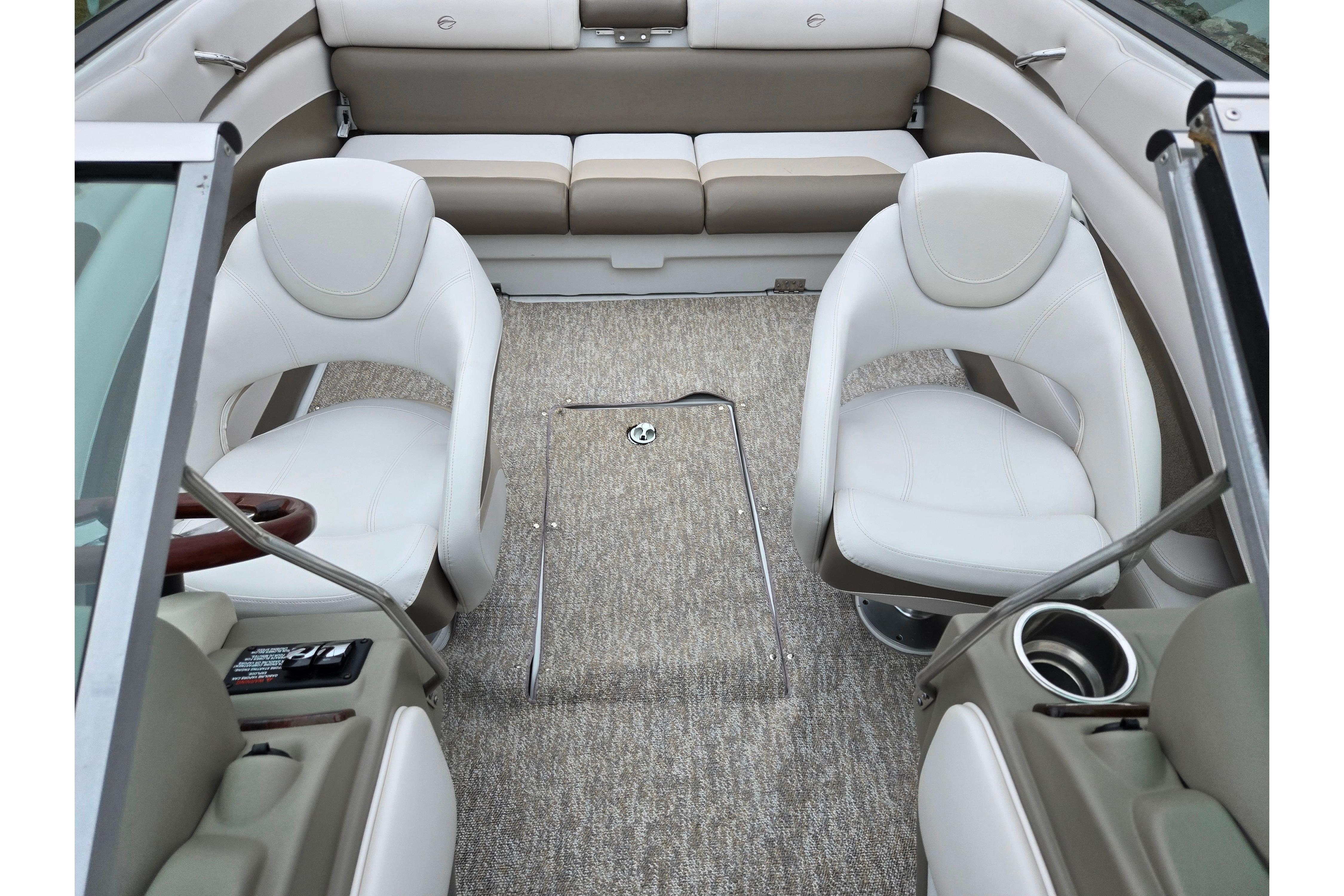 Interior of 2012 Crownline 235 SS boat with white seating and carpeted floor.