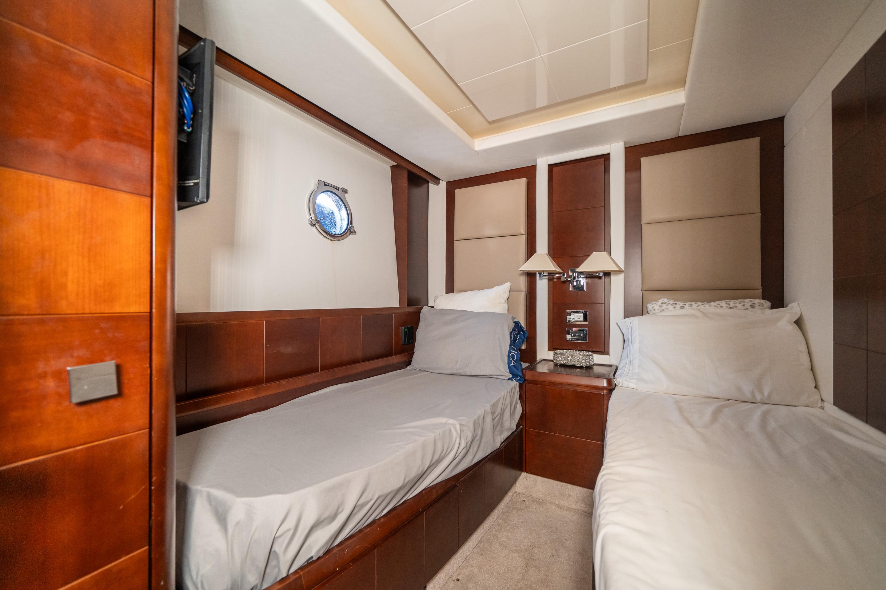 Luxurious cabin interior of 2010 Azimut 75 Fly yacht with twin beds.