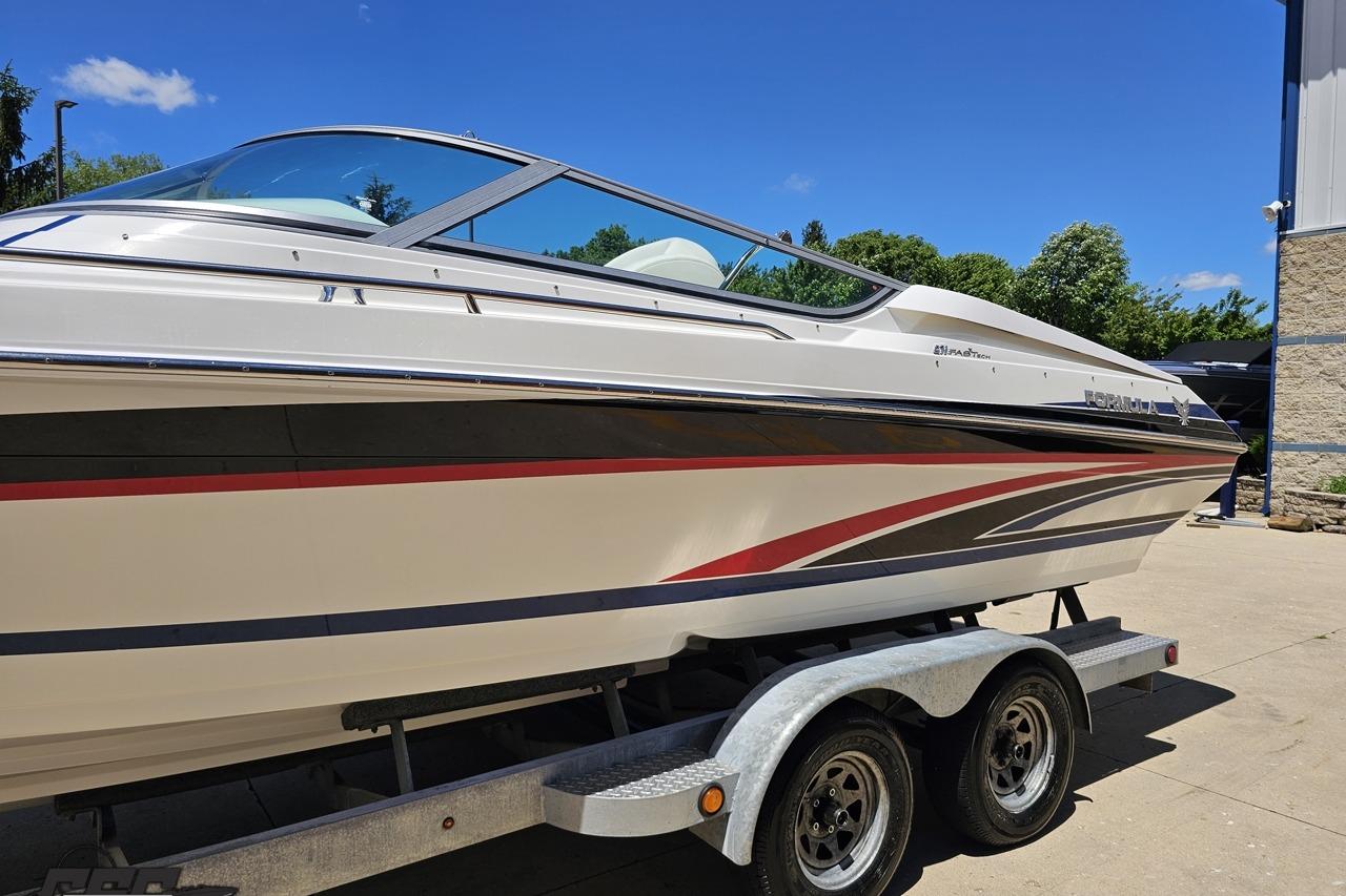 2005 Formula 271 FASTech boat on trailer, sleek design, sunny day background.
