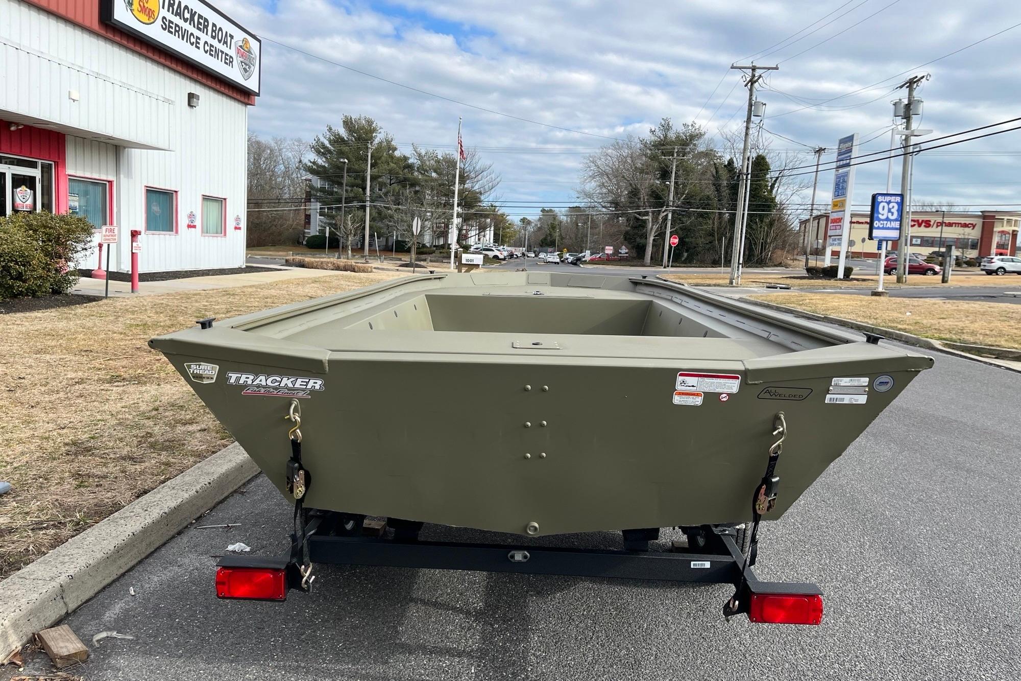 2026 Tracker Grizzly 1754 Utility boat on trailer outside service center.