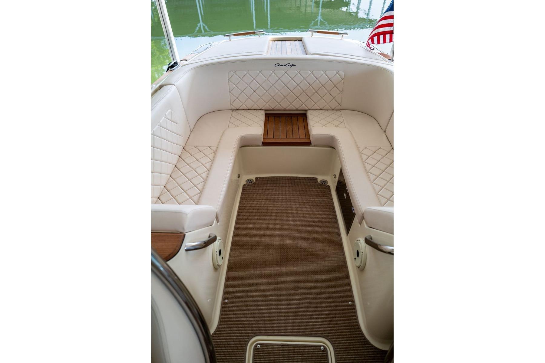 Luxurious interior of 2023 Chris-Craft Launch 27 boat with elegant seating and wood accents.