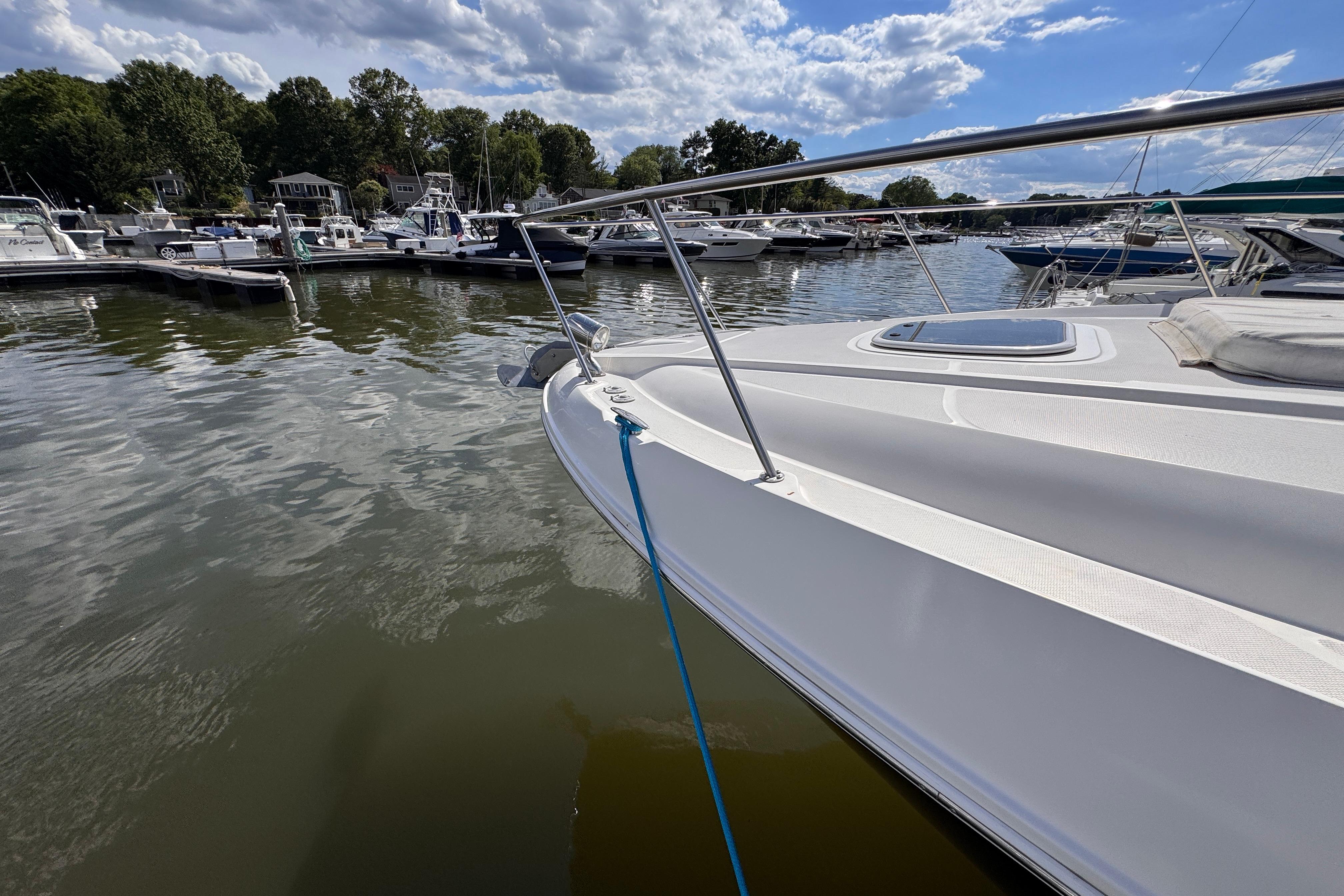 2008 Sea Ray Sundancer 350 docked at a marina under a partly cloudy sky.