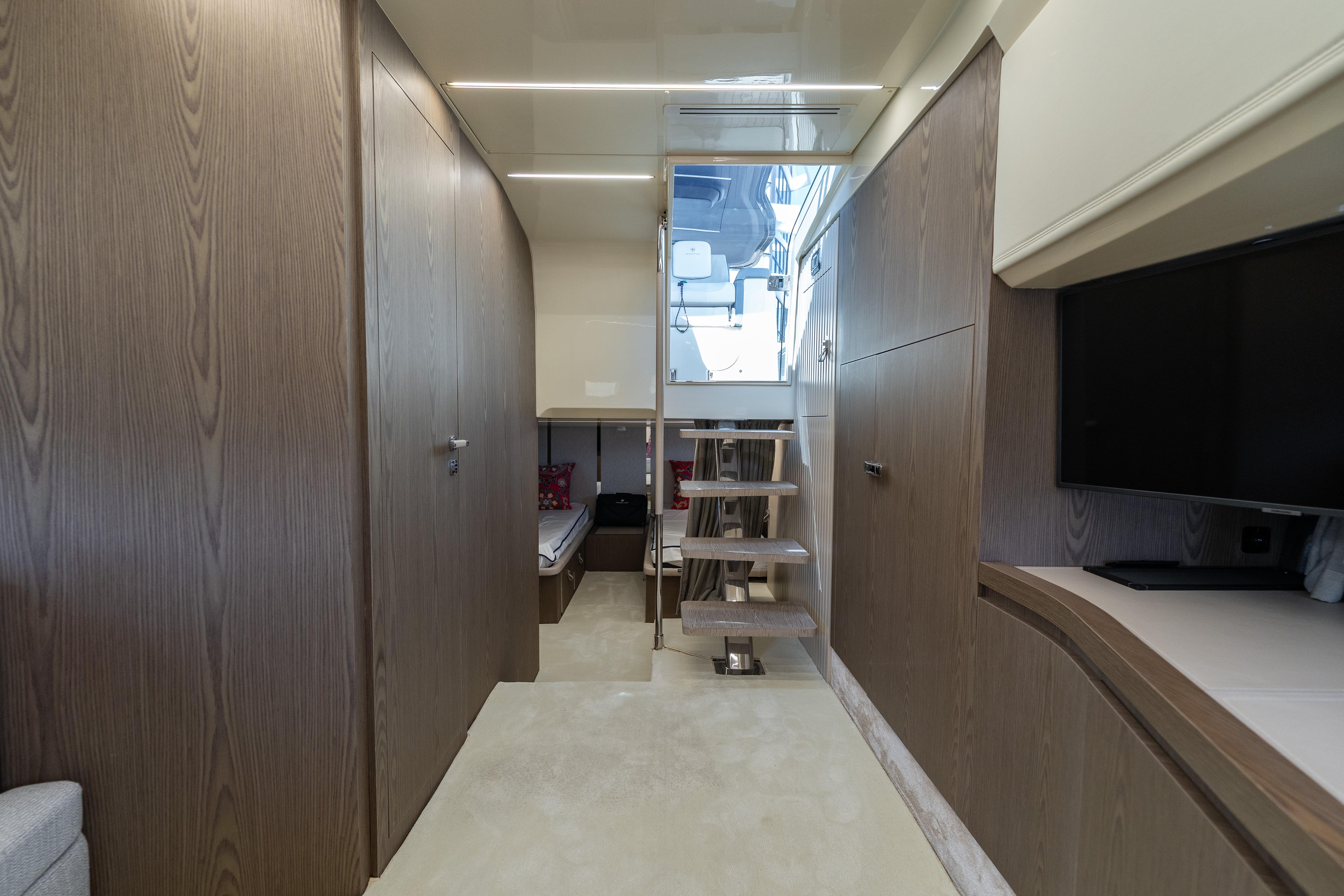 Luxurious interior of 2024 Invictus 460 yacht with modern wood finishes and sleek design.