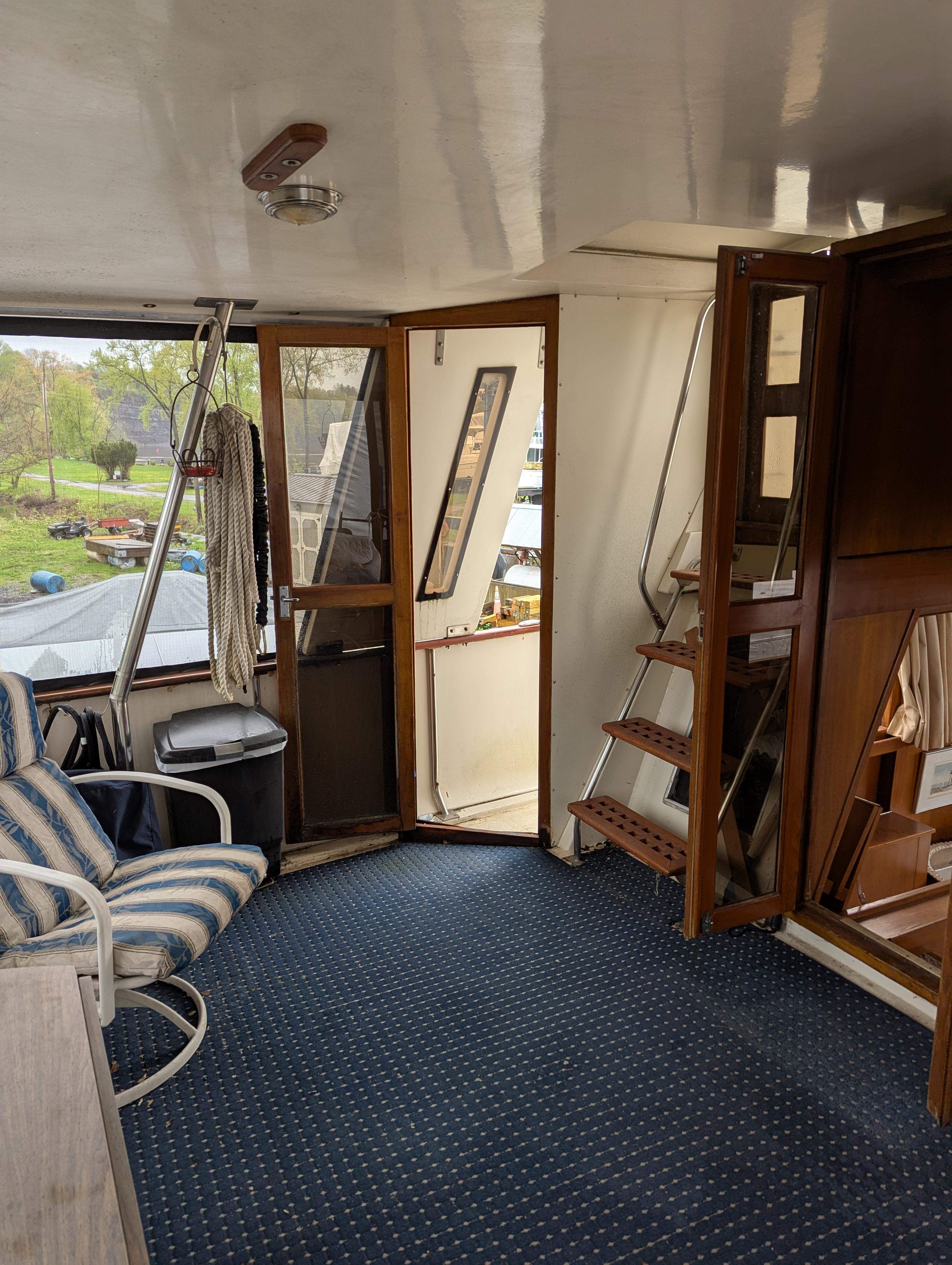 1989 Jefferson 42 SE Sundeck Motor Yacht interior with striped chair and wooden accents.
